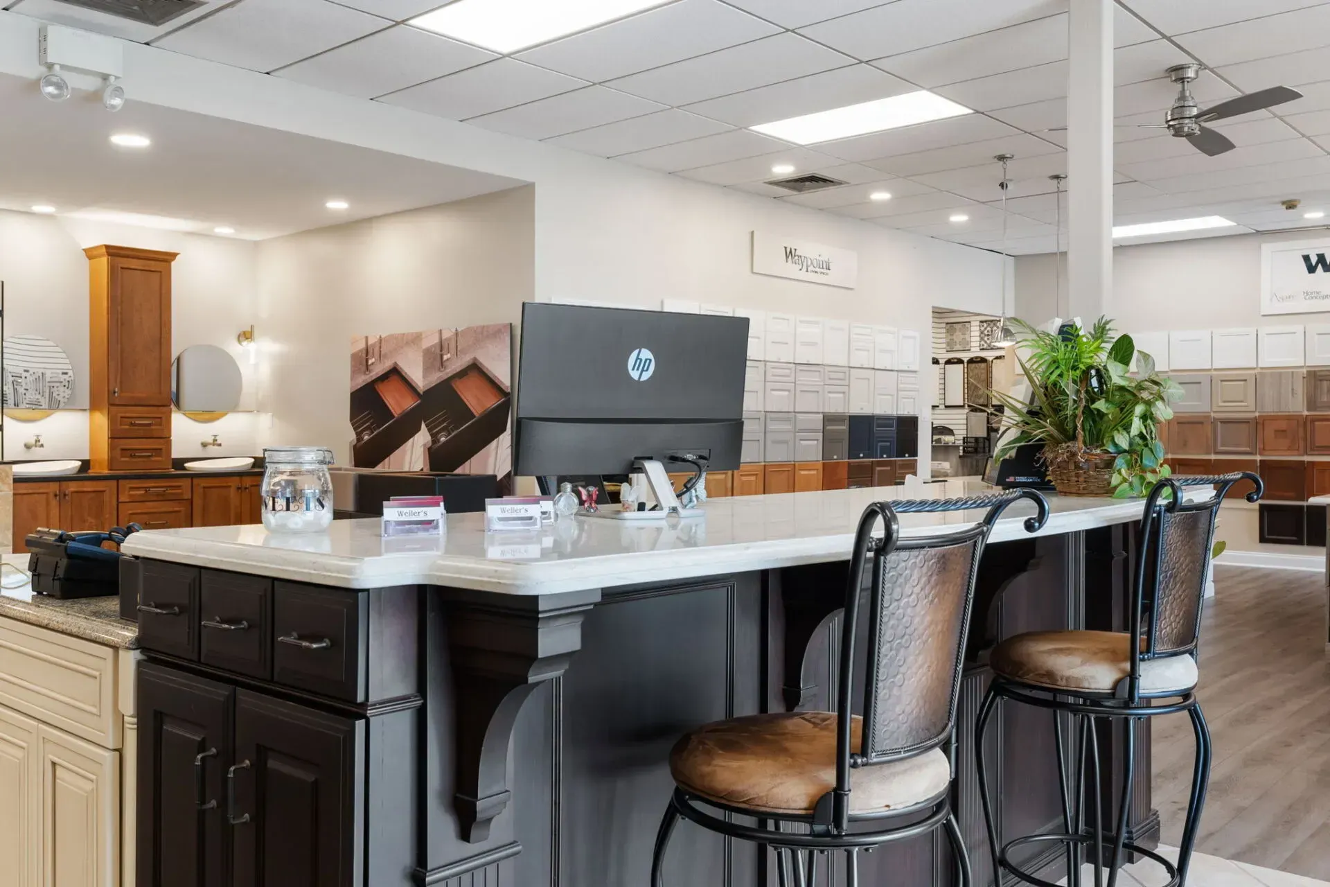 Modern kitchen showroom with island, bar stools, and display cabinets In Bucks Country PA