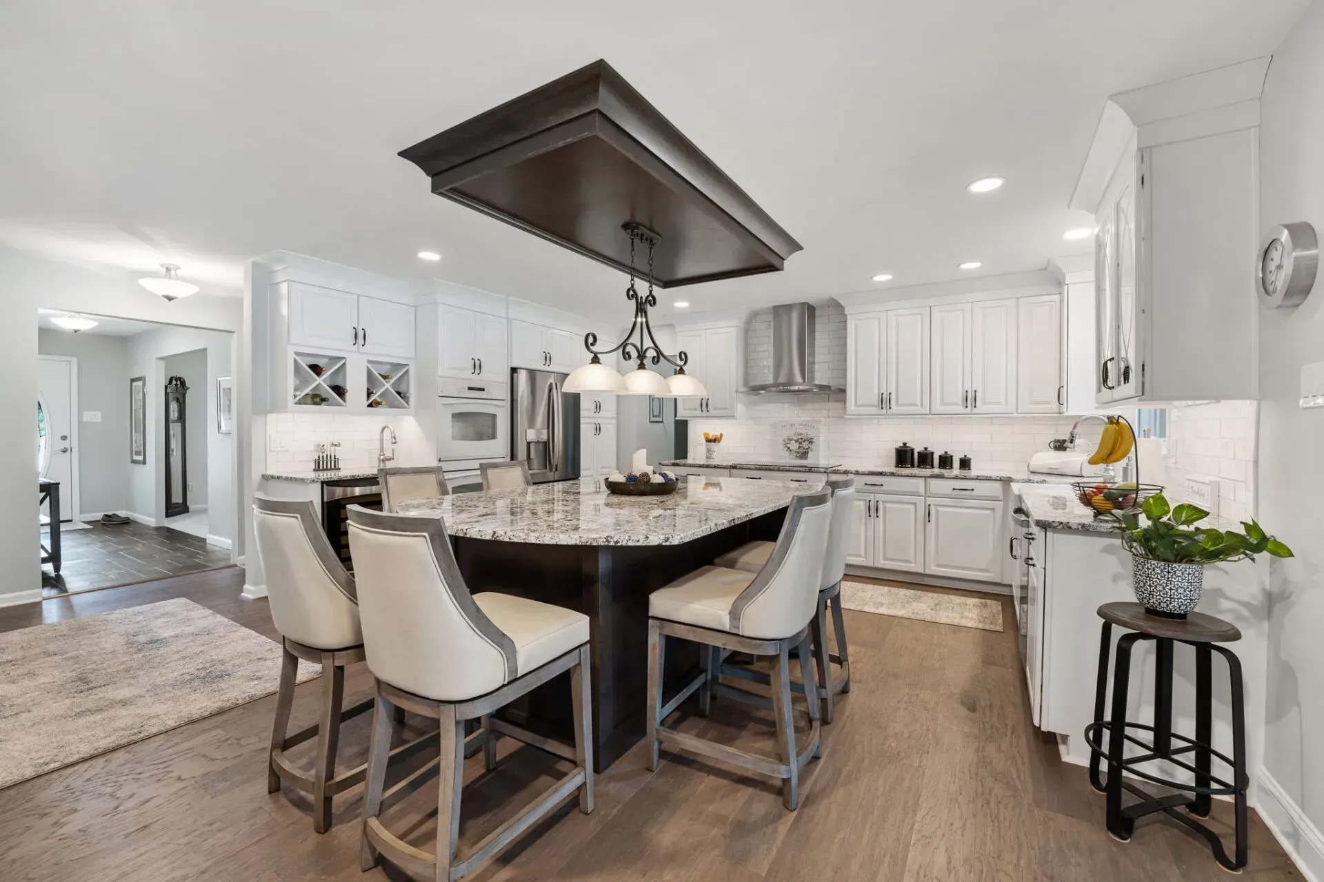 Modern kitchen with white cabinets, island seating, and pendant lighting In Bucks County PA