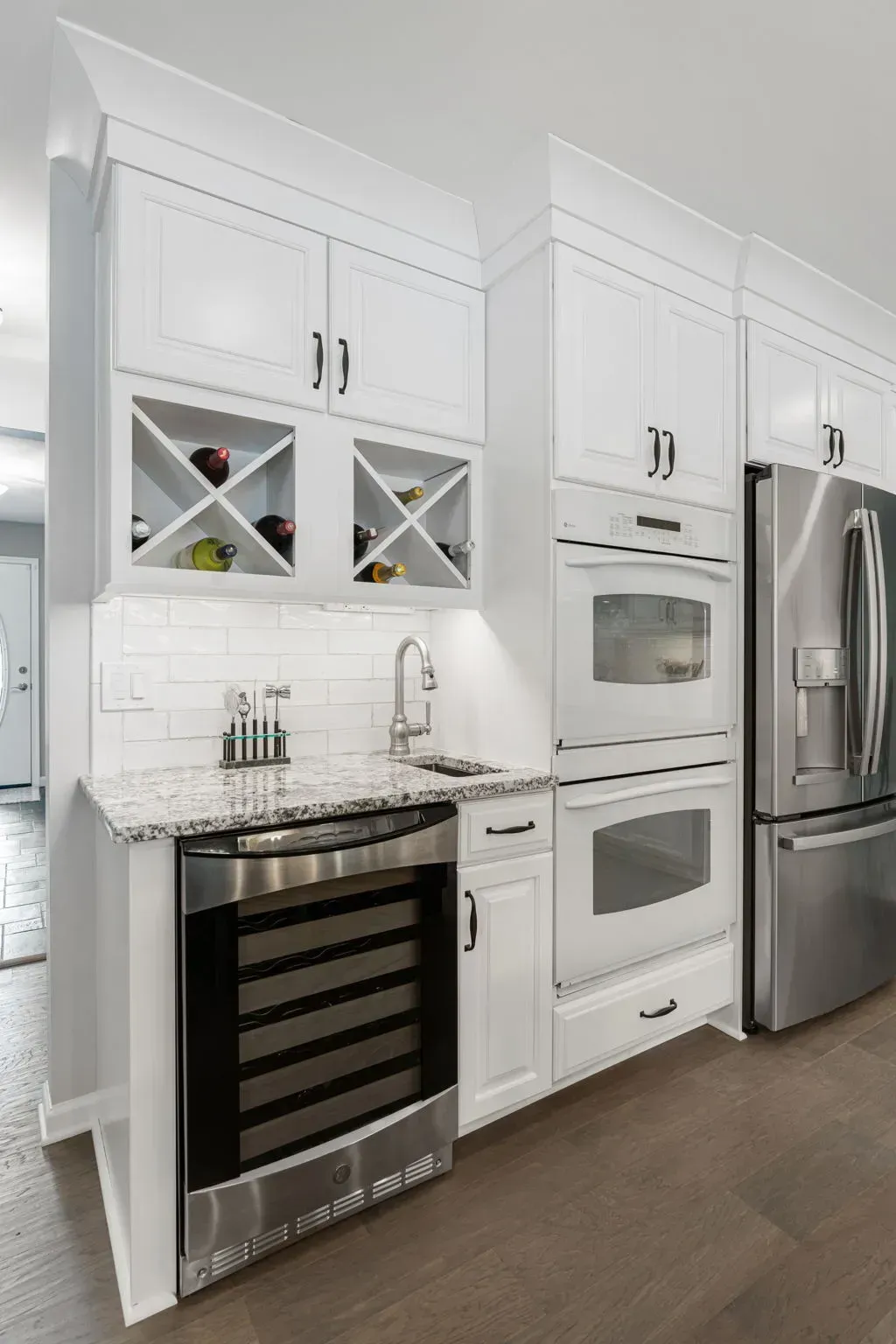 White modern kitchen with stainless steel appliances and built-in oven units In Bucks County PA