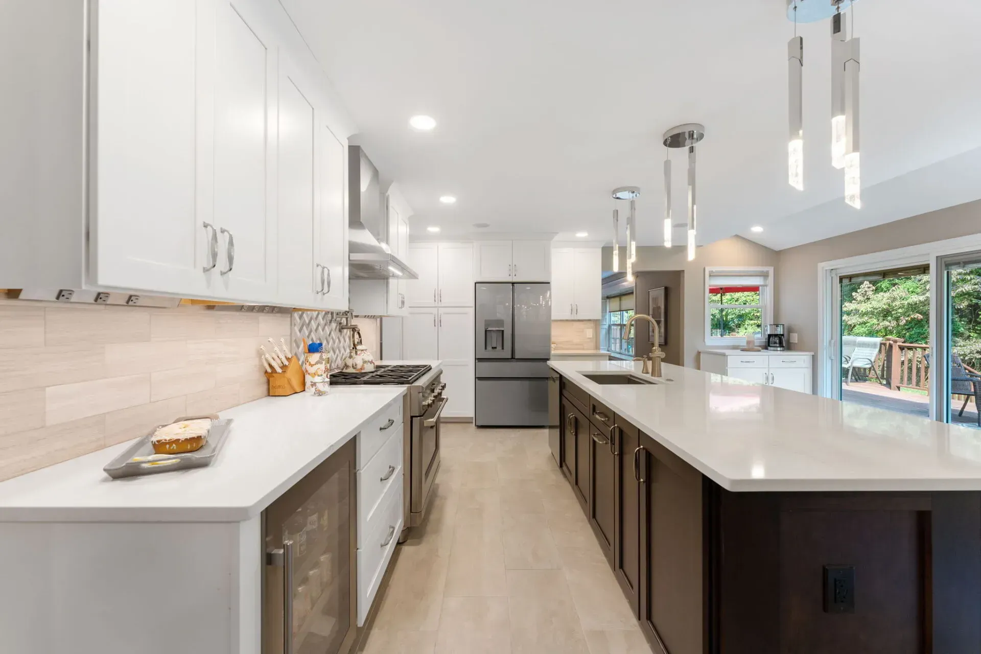 Bright modern kitchen with white cabinets, long island, and stainless-steel appliances In Bucks County PA