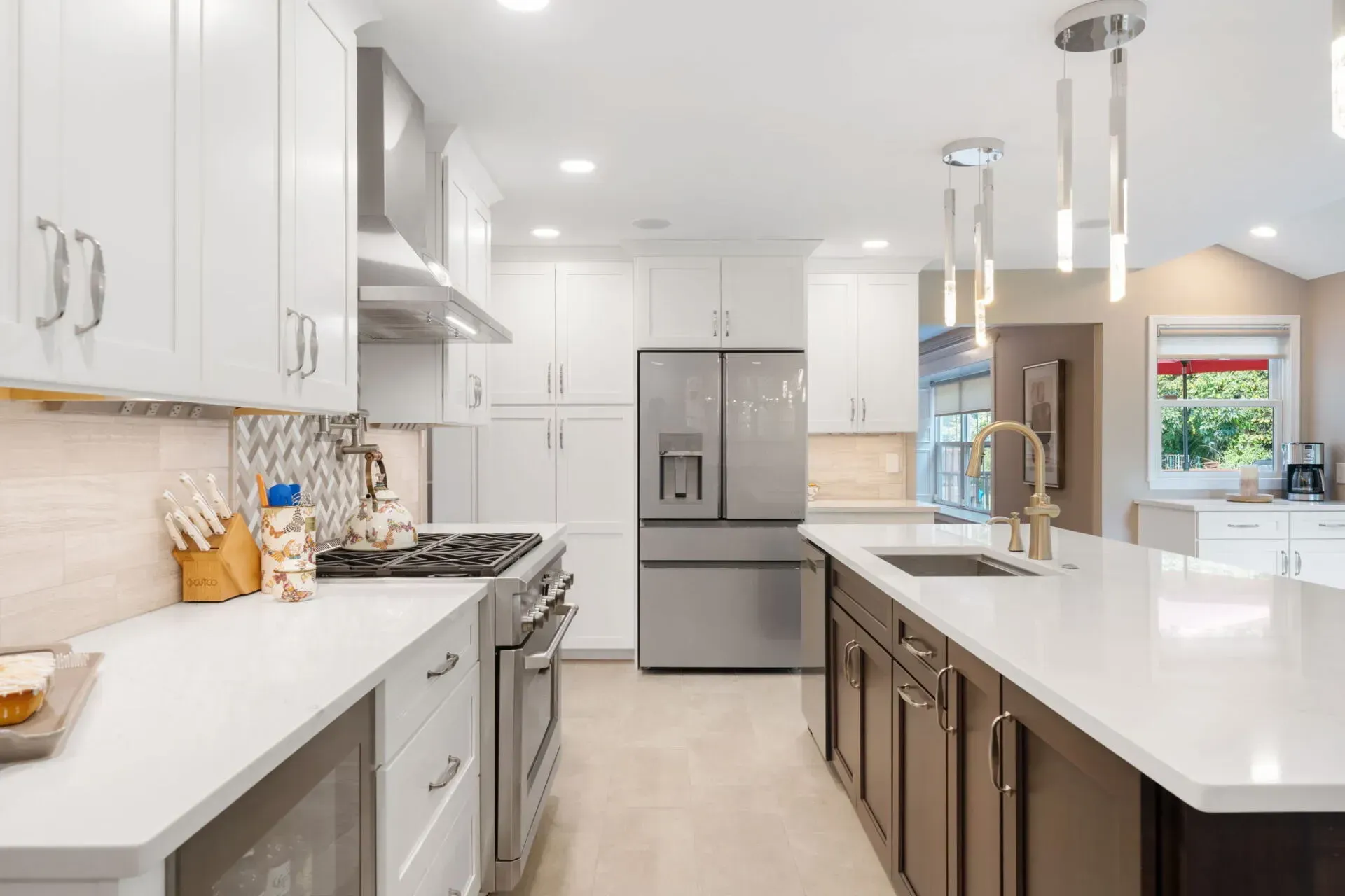 Bright modern kitchen with white cabinets, stainless steel appliances, and a large island In Bucks County PA