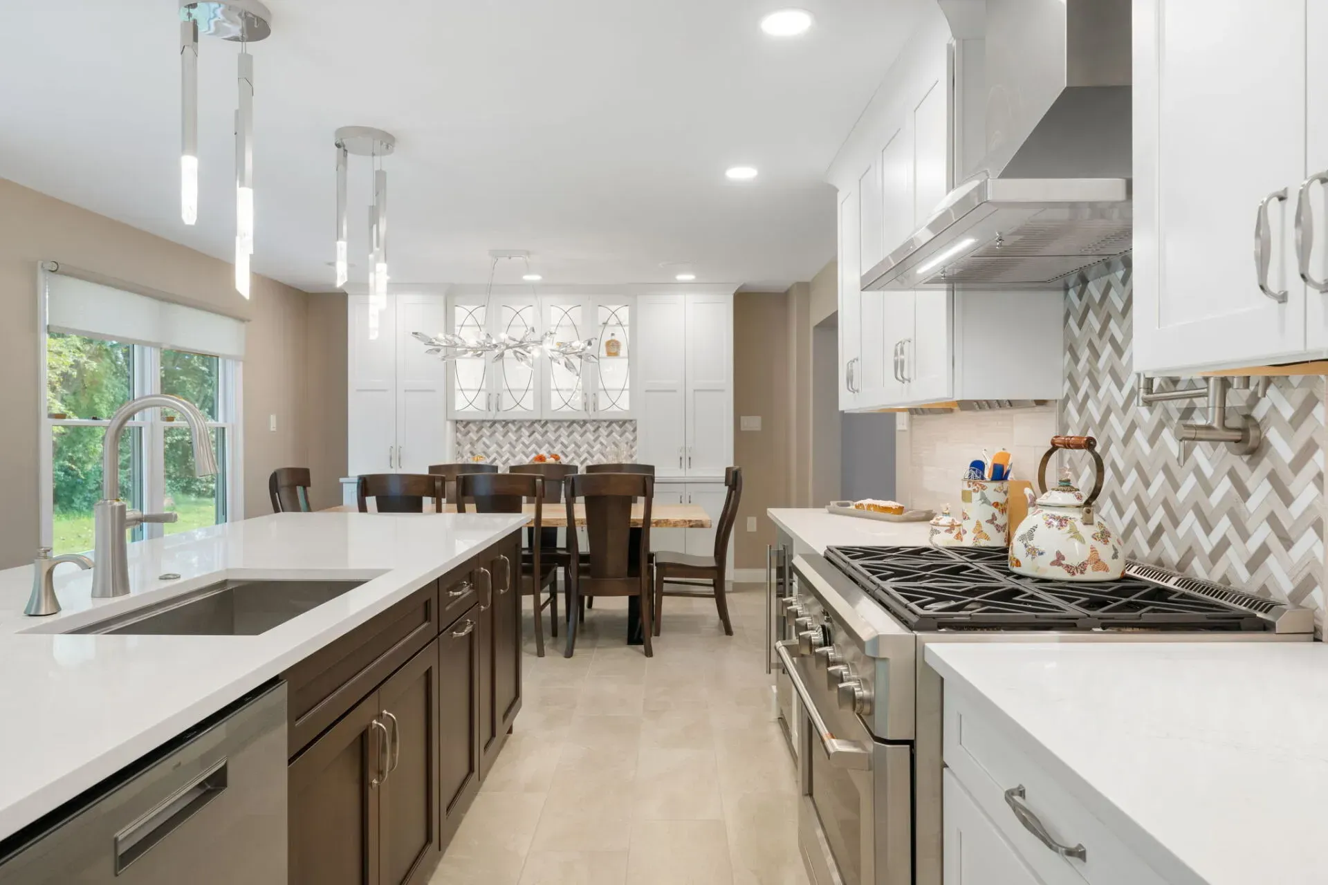Bright modern kitchen with white cabinets, stainless appliances, and a dining area beyond In Bucks County PA