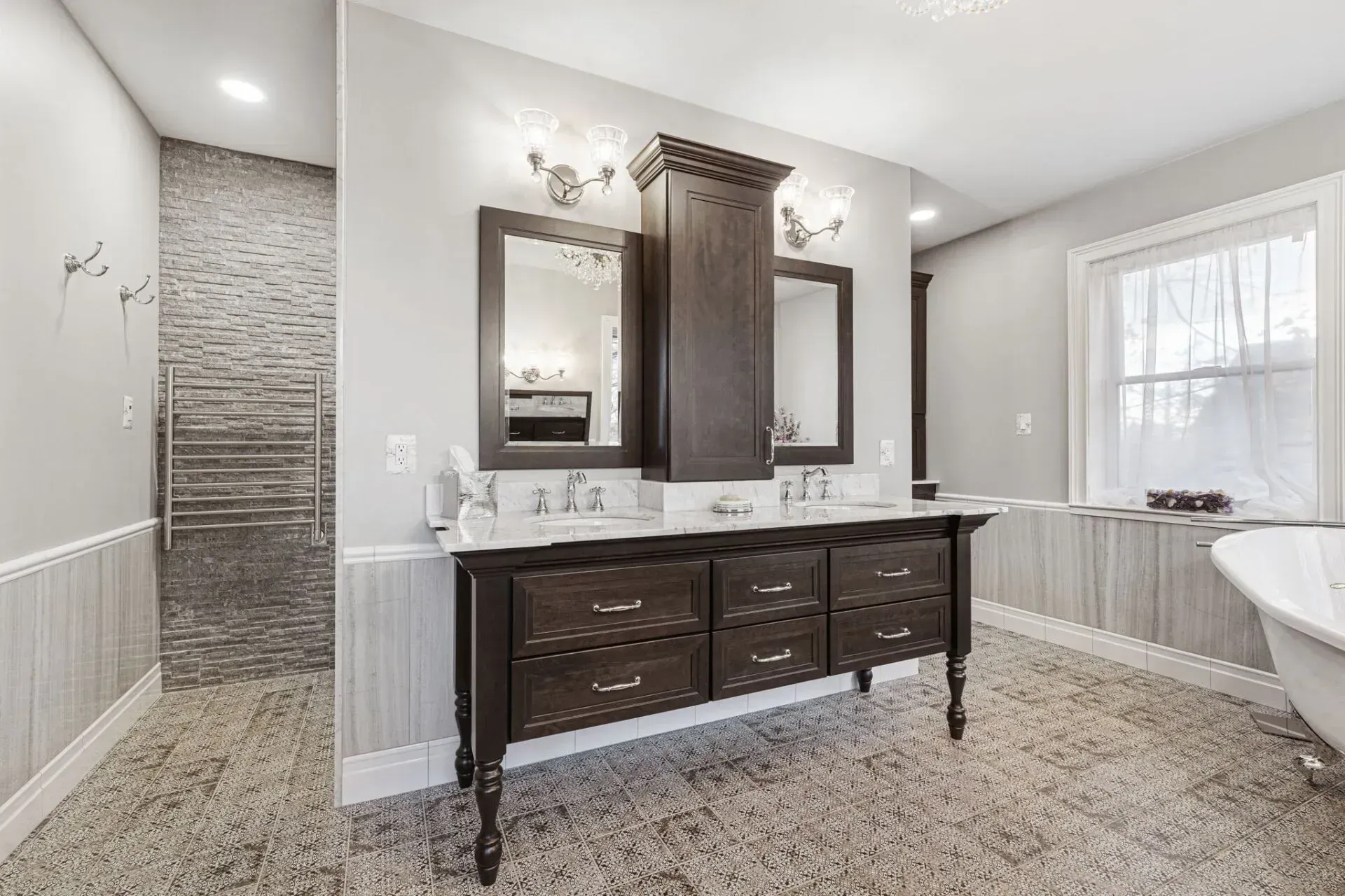Modern bathroom with double vanity, dark wood cabinets, and a tiled shower niche by a bright window in Bucks County PA