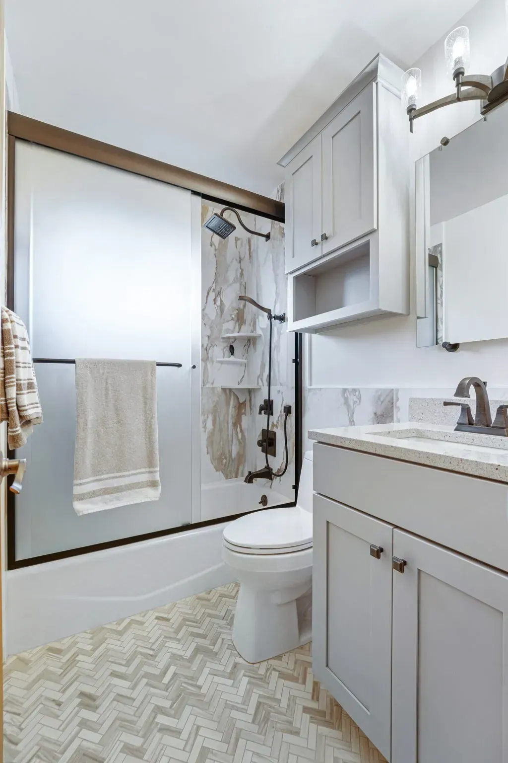 Small bathroom with shower curtain, toilet, vanity, and mirror in white and gray tones In Bucks County PA