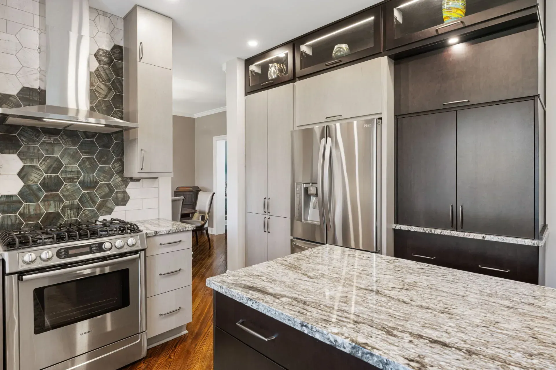 Modern kitchen with stainless steel appliances, dark cabinets, and a granite island countertop  In Bucks County PA