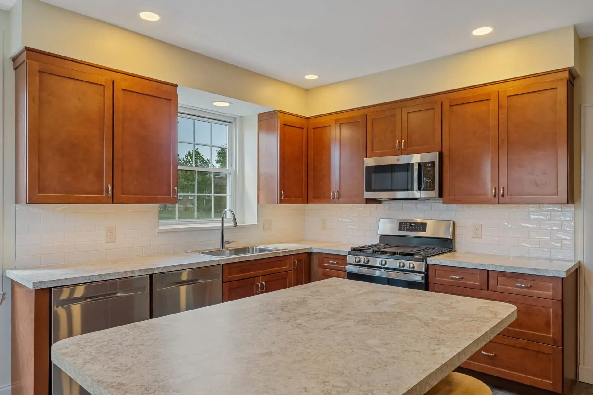 Bright kitchen with wooden cabinets, stainless steel appliances, and a large center island  In Bucks County PA
