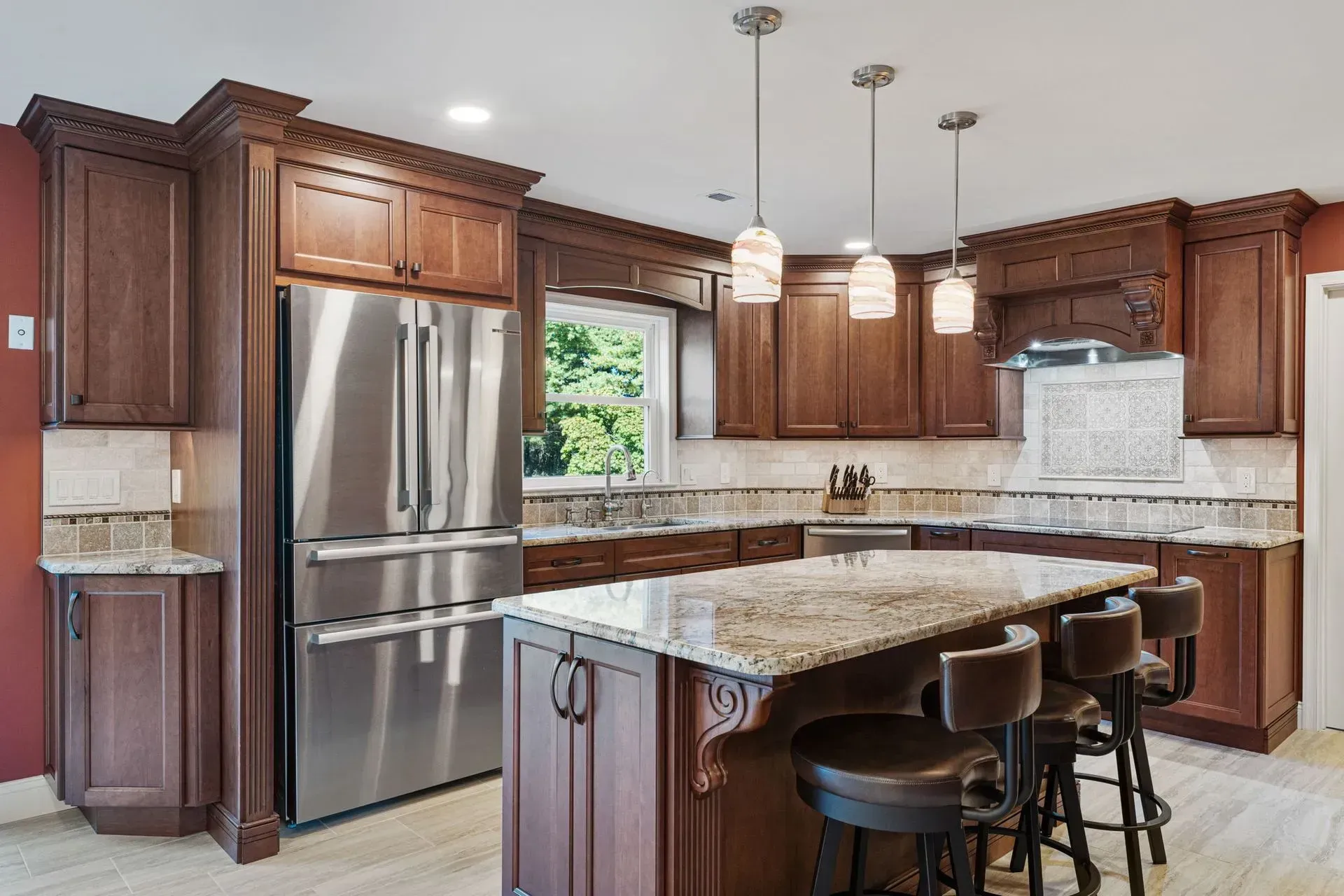 Modern kitchen with dark wood cabinets, granite island, stainless steel appliances, and pendant lights  In Bucks County PA