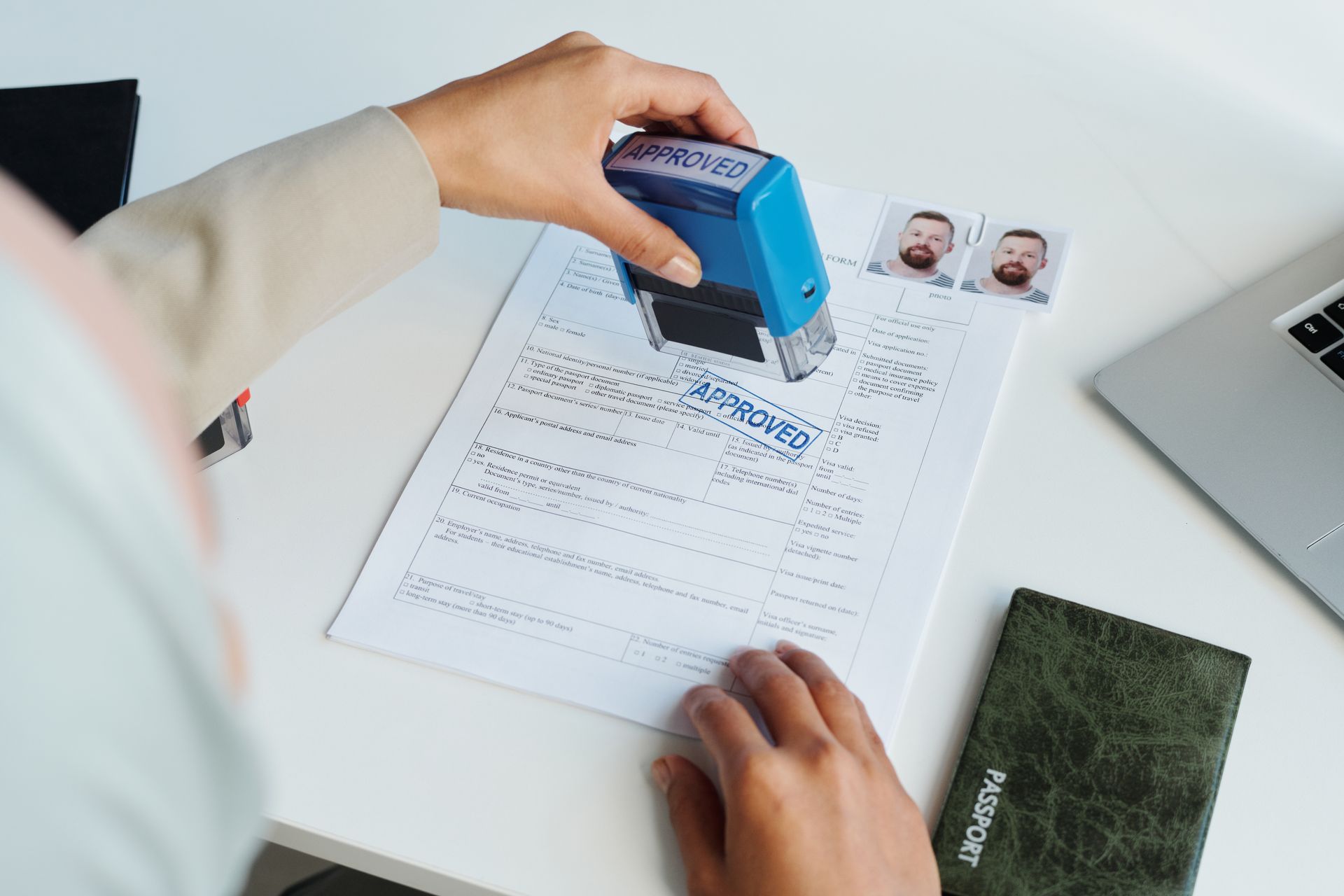 A person is putting a stamp on a piece of paper.