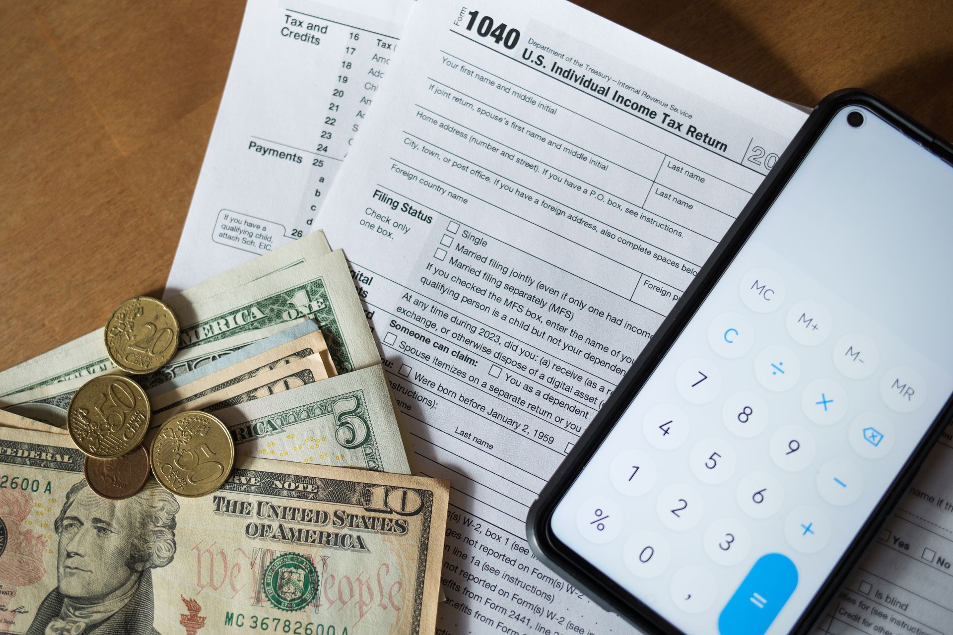 A cell phone is sitting on top of a 1040 tax form.
