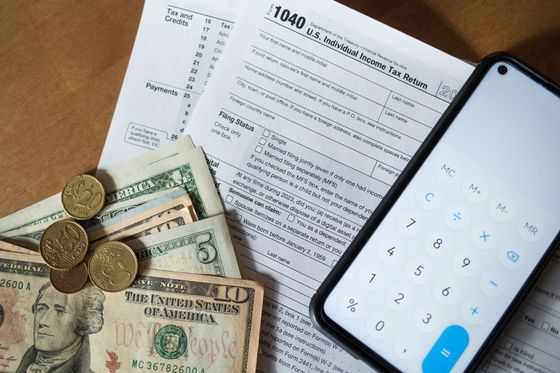 A cell phone is sitting on top of a 1040 tax form.