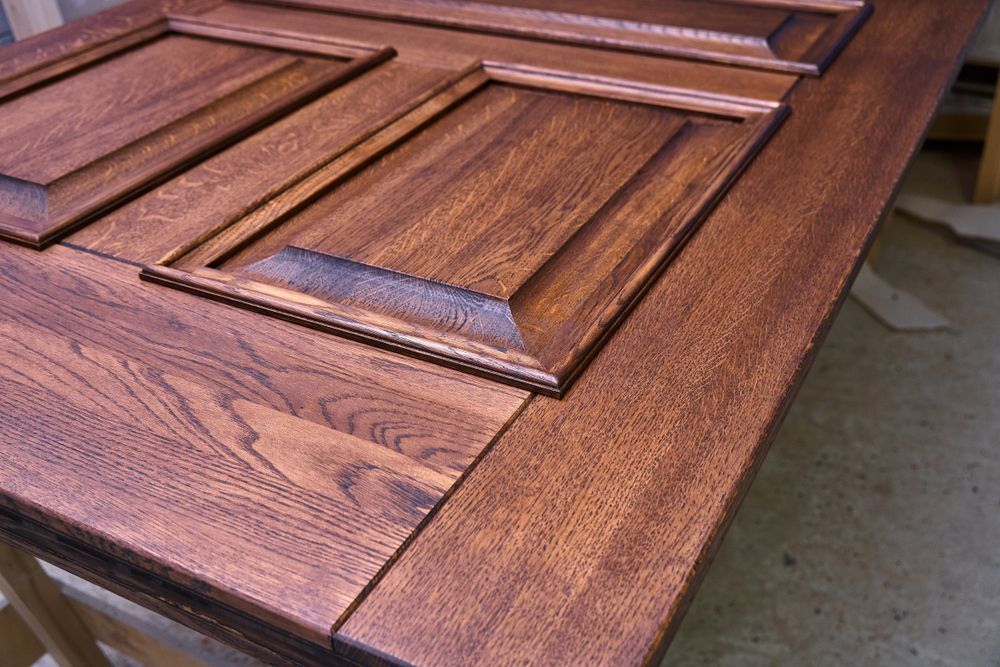 Close-up of a Stained Wooden Door With Raised Panels — Dachboe Your Handyman In Townsville, QLD