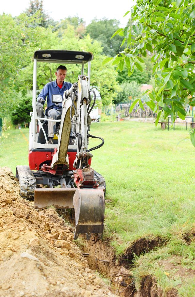 Man Operating a Small Excavator — Dachboe Your Handyman In Townsville, QLD