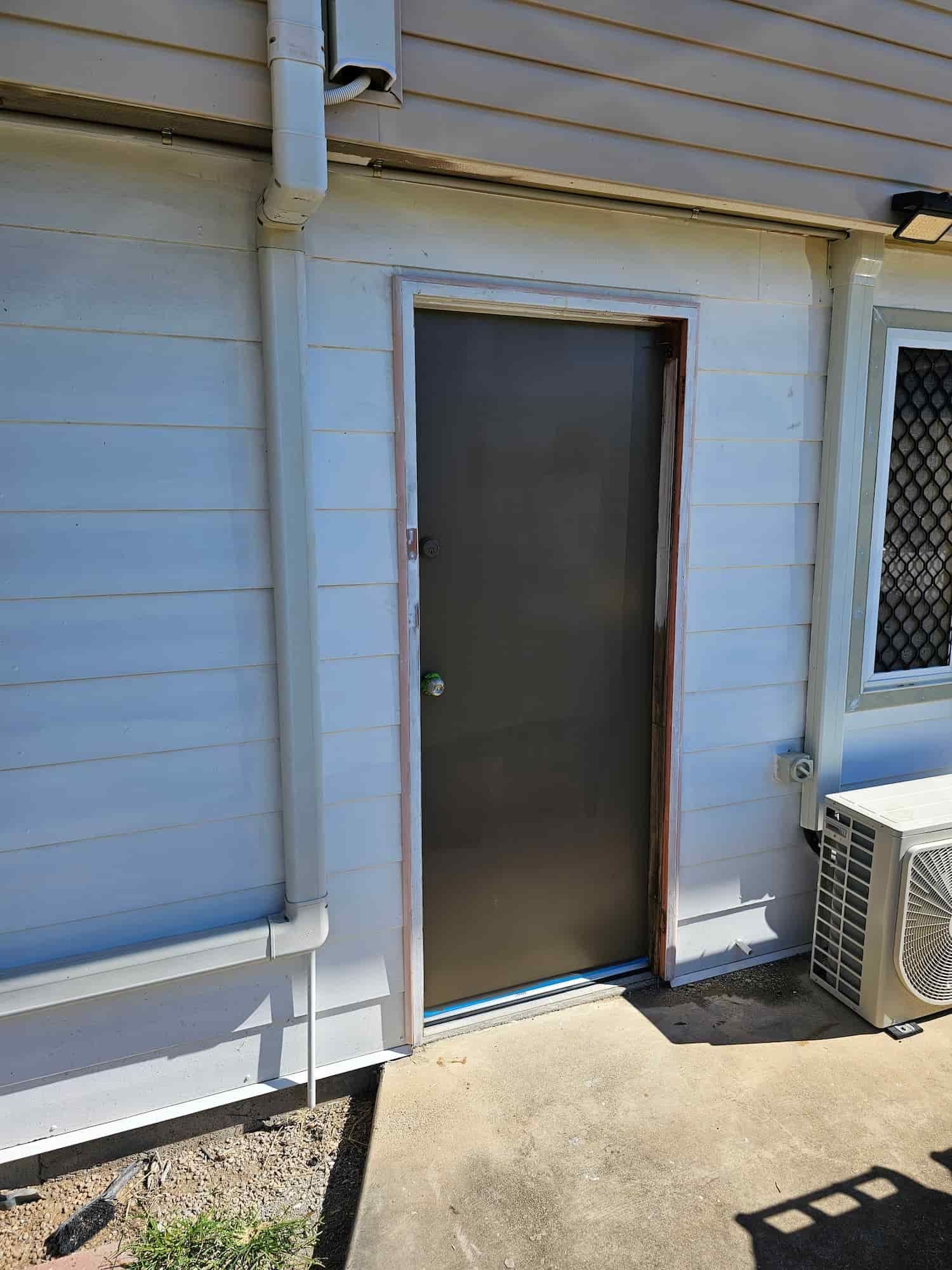 A White House With A Black Door And A Window — Dachboe Your Handyman in Townsville, QLD