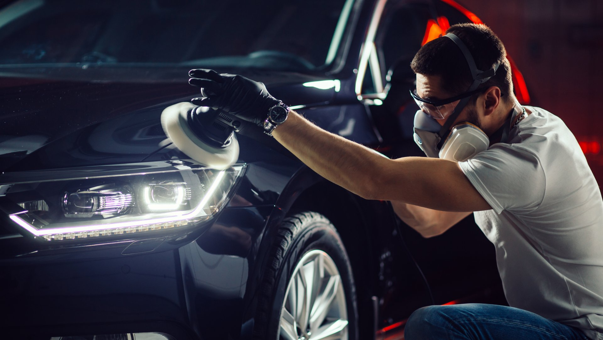 man buffing car headlights