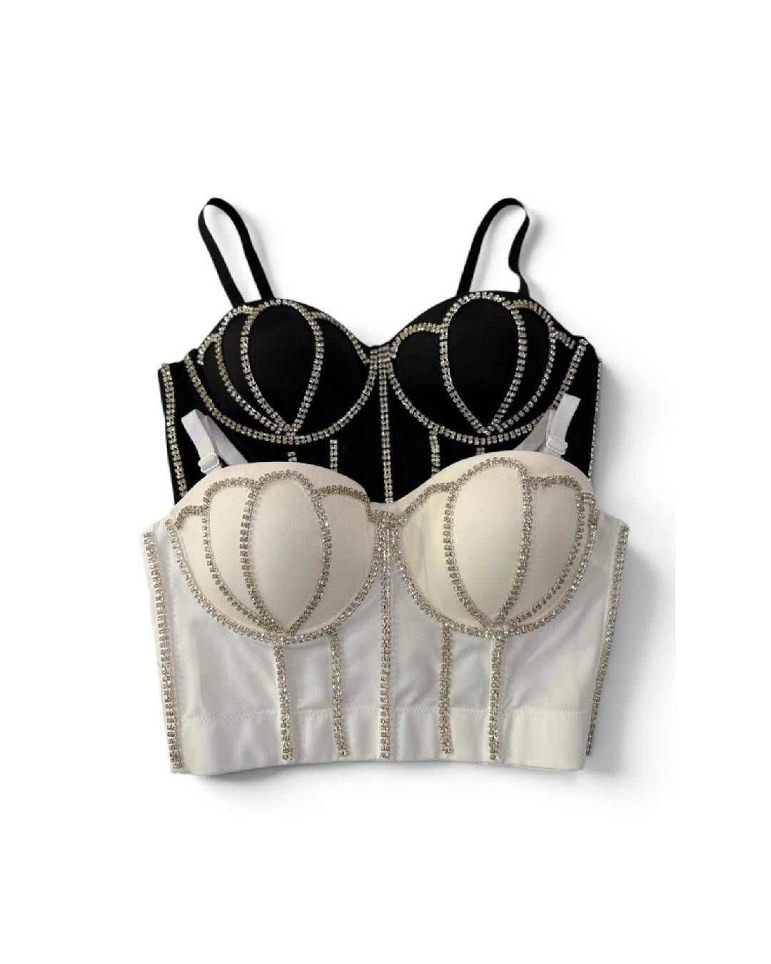 Dos tops estilo corsé apilados, uno negro y otro blanco, con tirantes finos y ribetes decorativos.