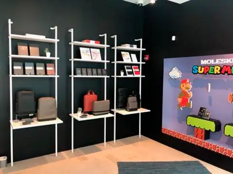A room with shelves and a picture of super mario on the wall.