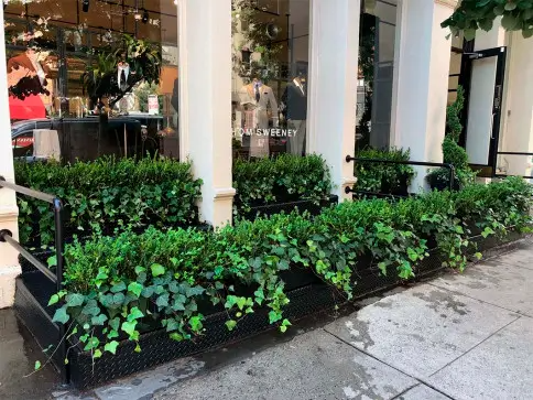 A building with a lot of plants in front of it