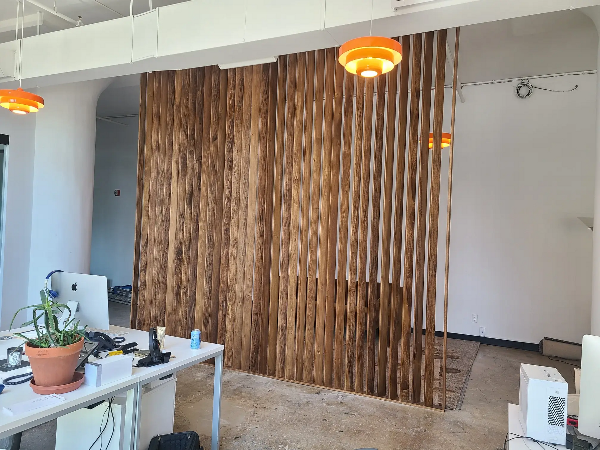 There is a wooden wall in the middle of the room.