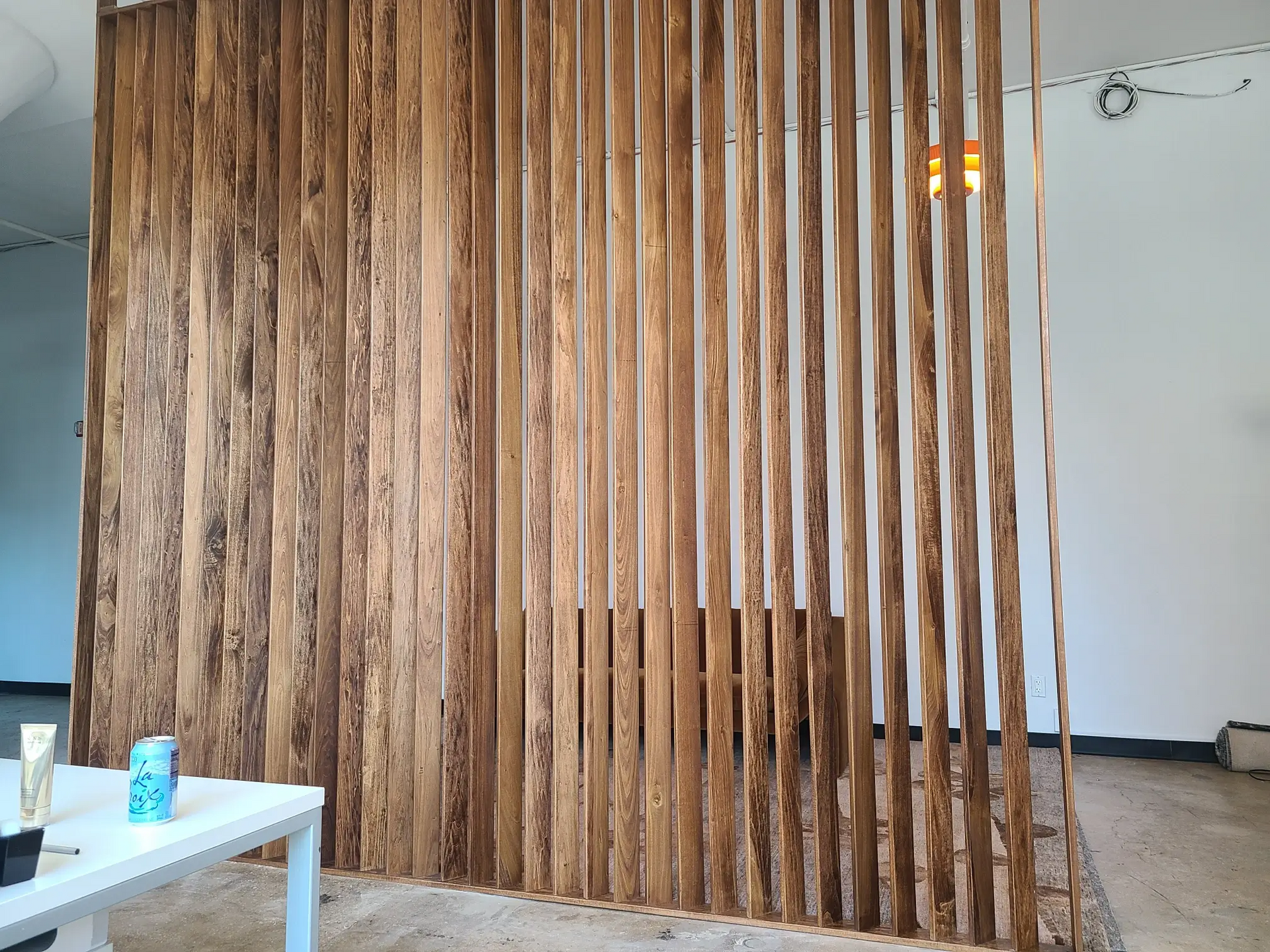 A room divider made of wooden slats in a living room.