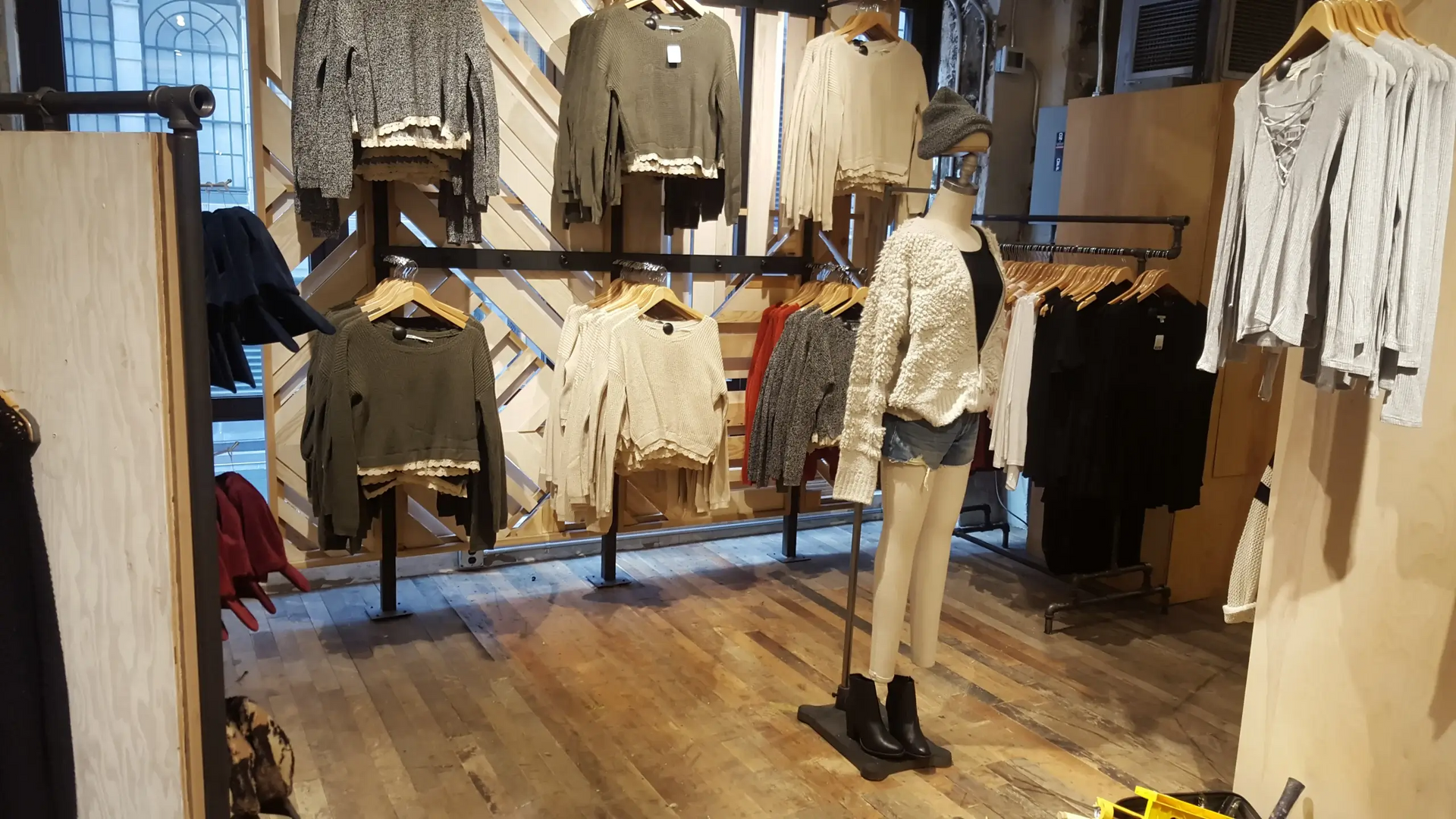 A store filled with clothes and a mannequin.
