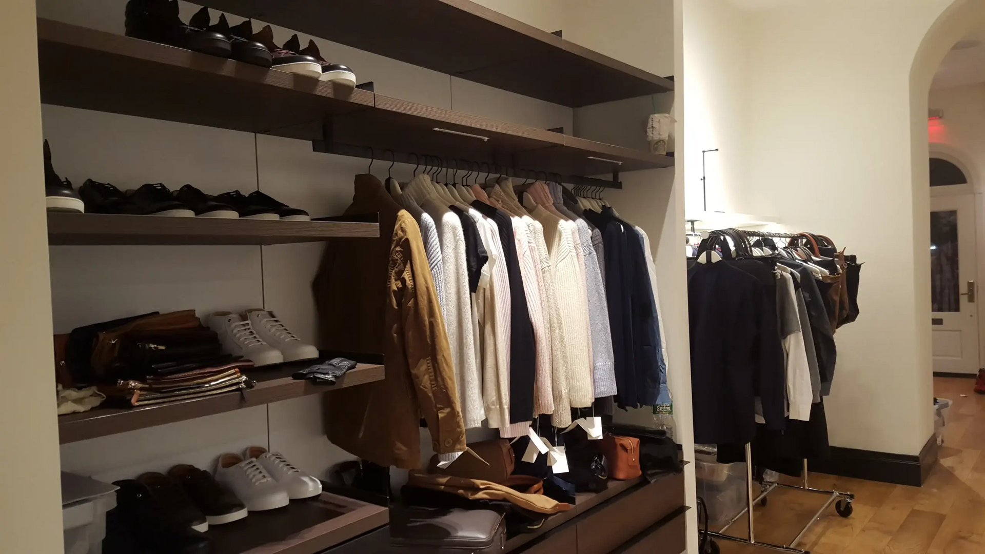 A closet filled with clothes and shoes in a store