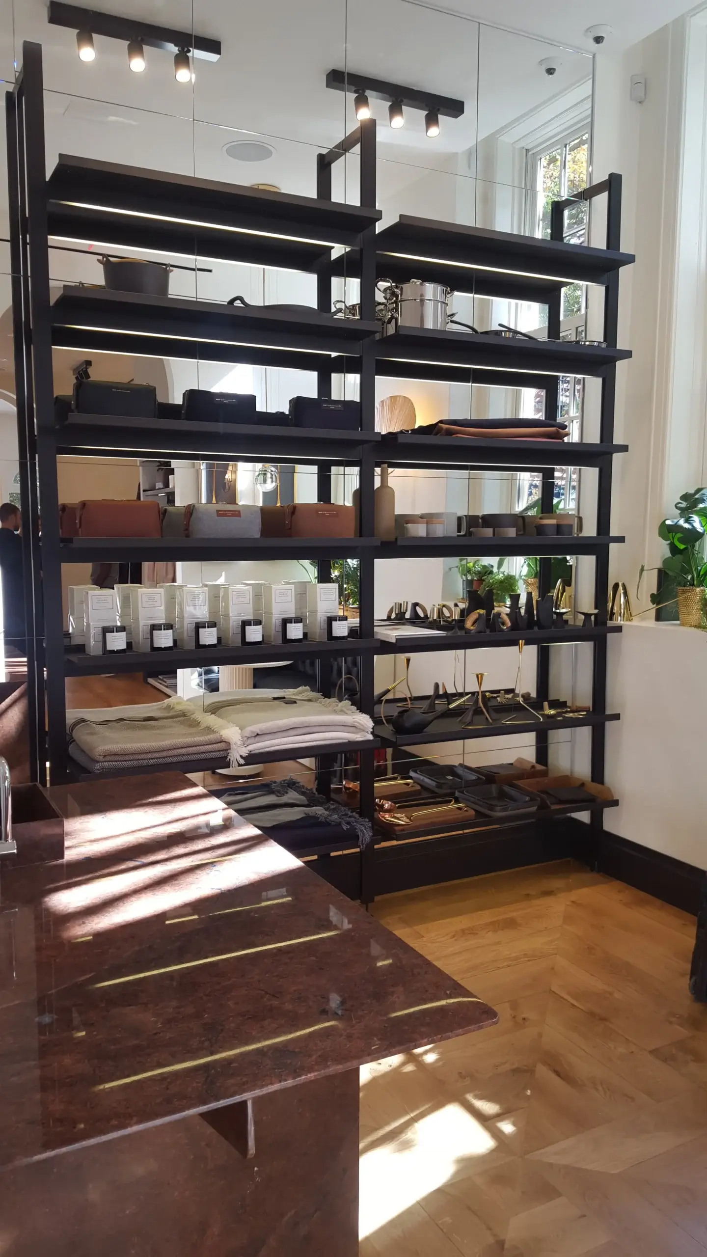 A room with a lot of shelves and a table