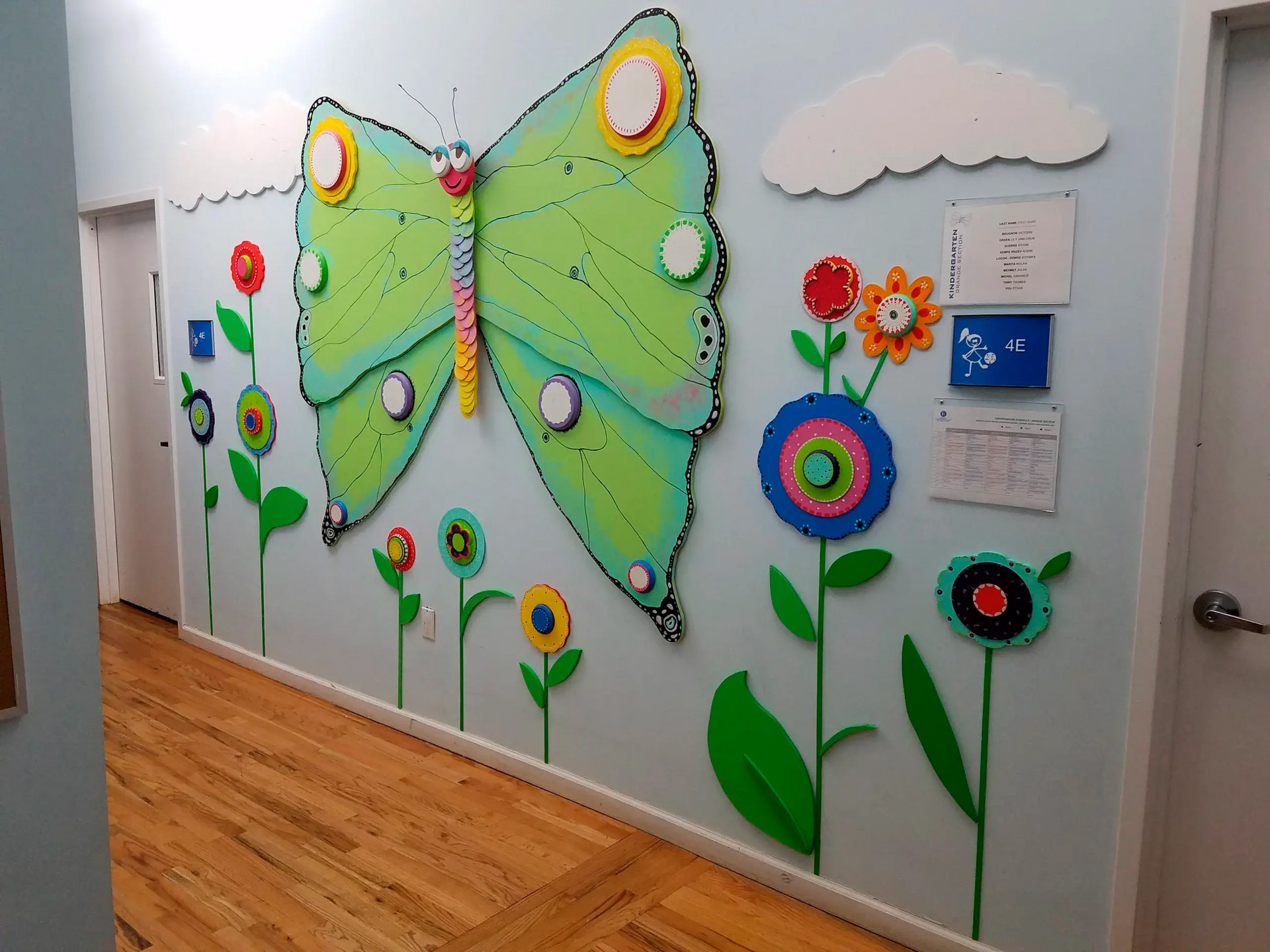 A hallway with a butterfly and flowers on the wall