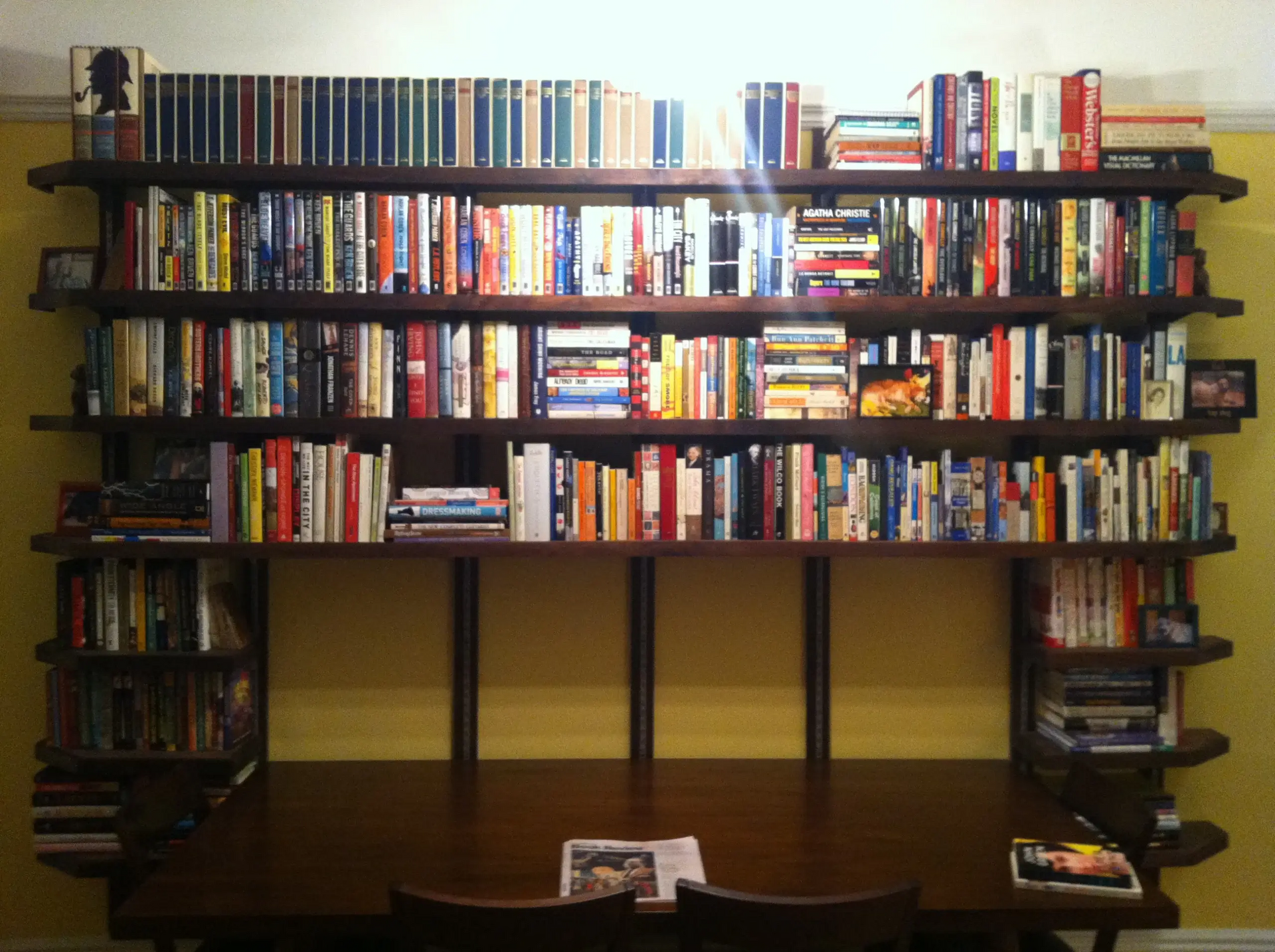 A bookshelf with a lot of books on it