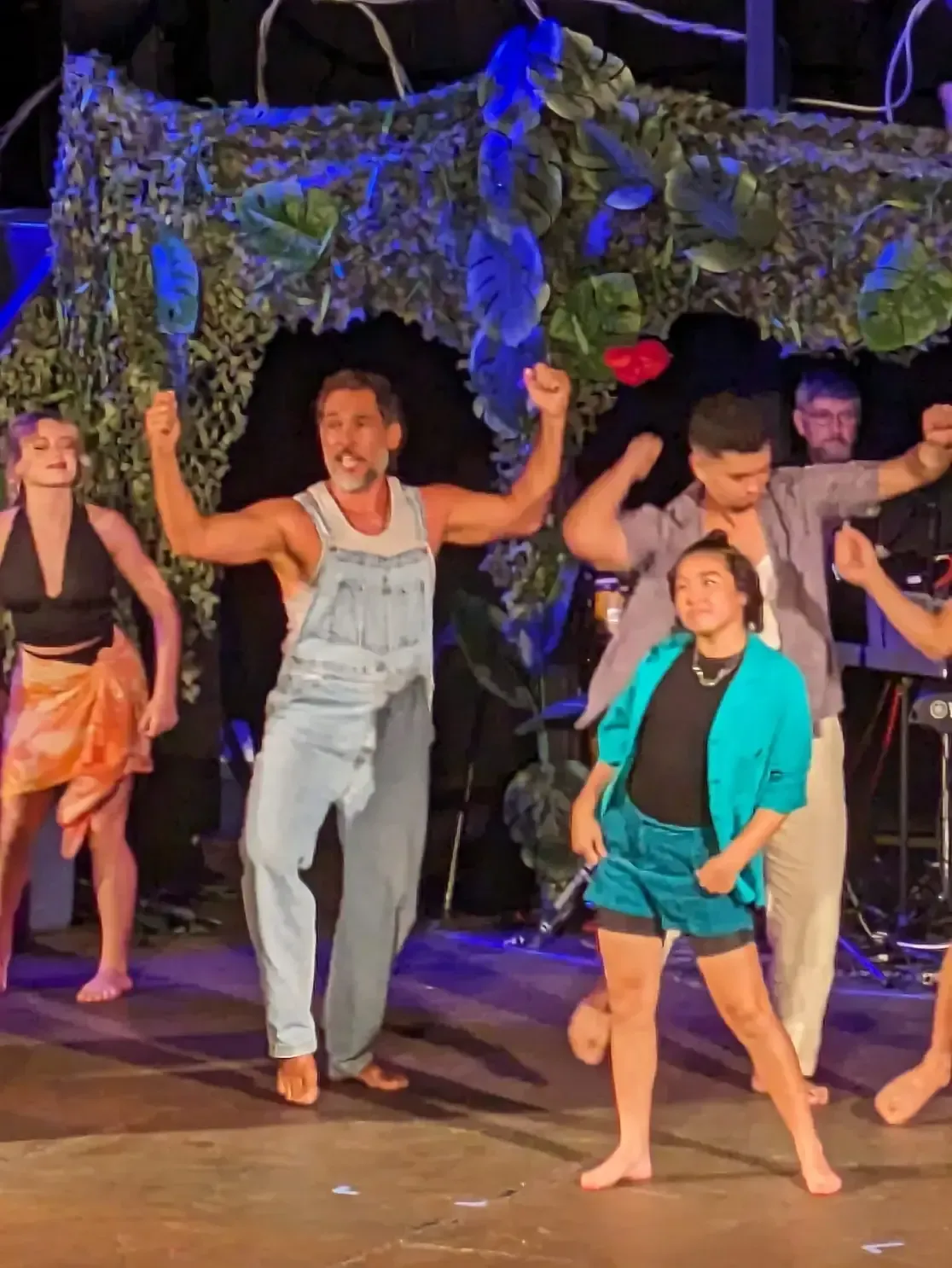A group of people are dancing on a stage.