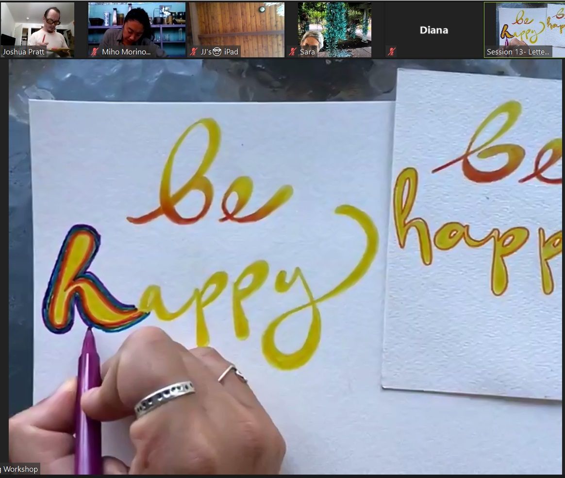 A person is writing be happy on a piece of paper