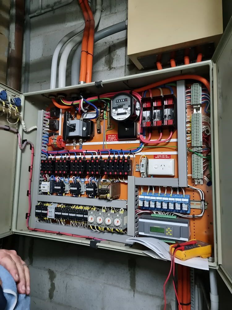 A person is standing in front of a large electrical box — Davey Service & Maintenance Qld In Clinton, QLD