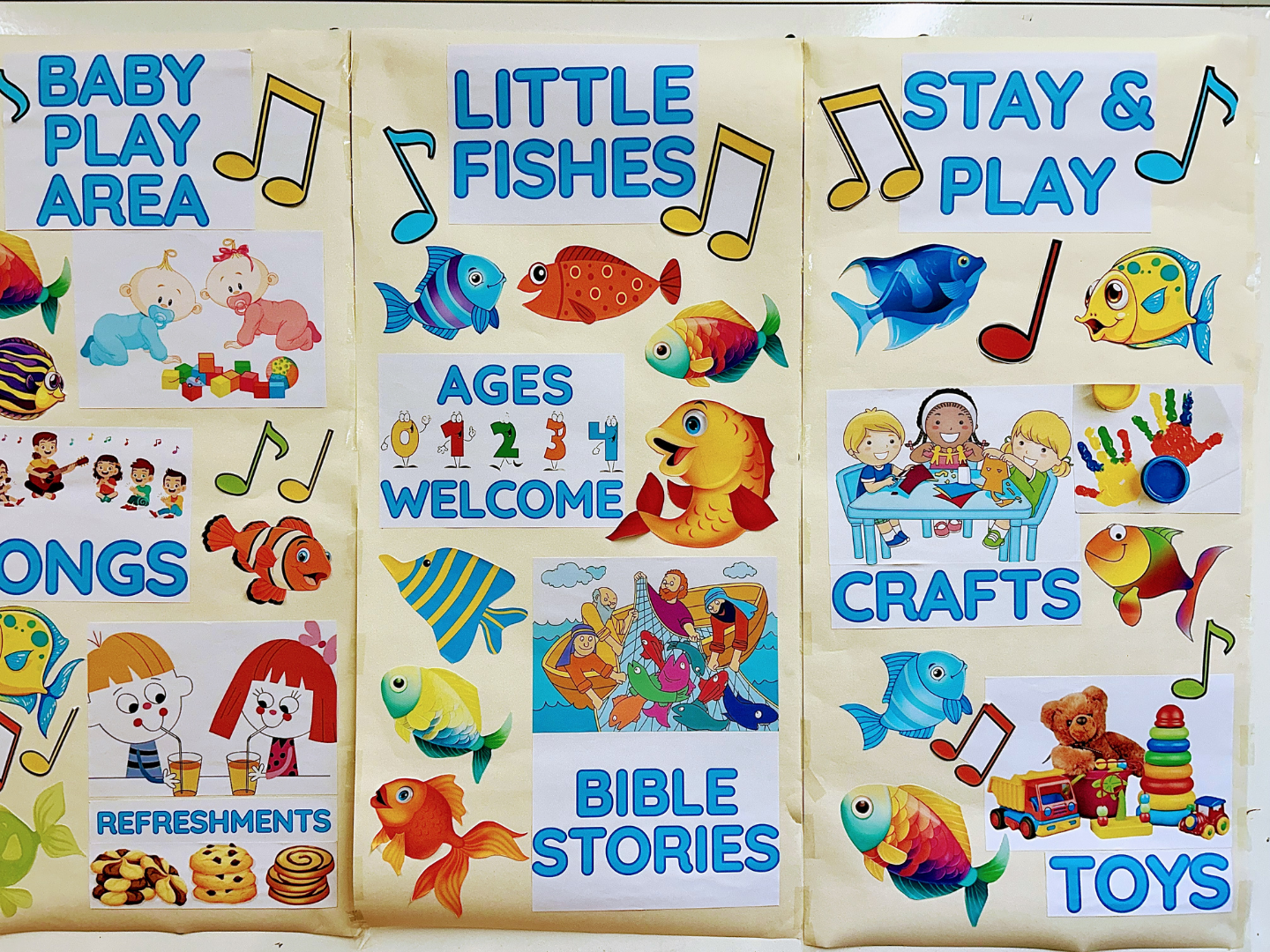 Three posters labeled Baby Play Area, Little Fishes, and Stay & Play, featuring colorful cartoon fish and children's themes.