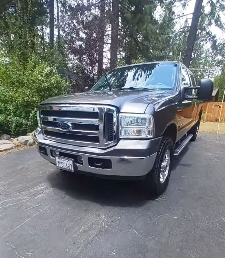 A ford f250 super duty truck is parked in a driveway.
