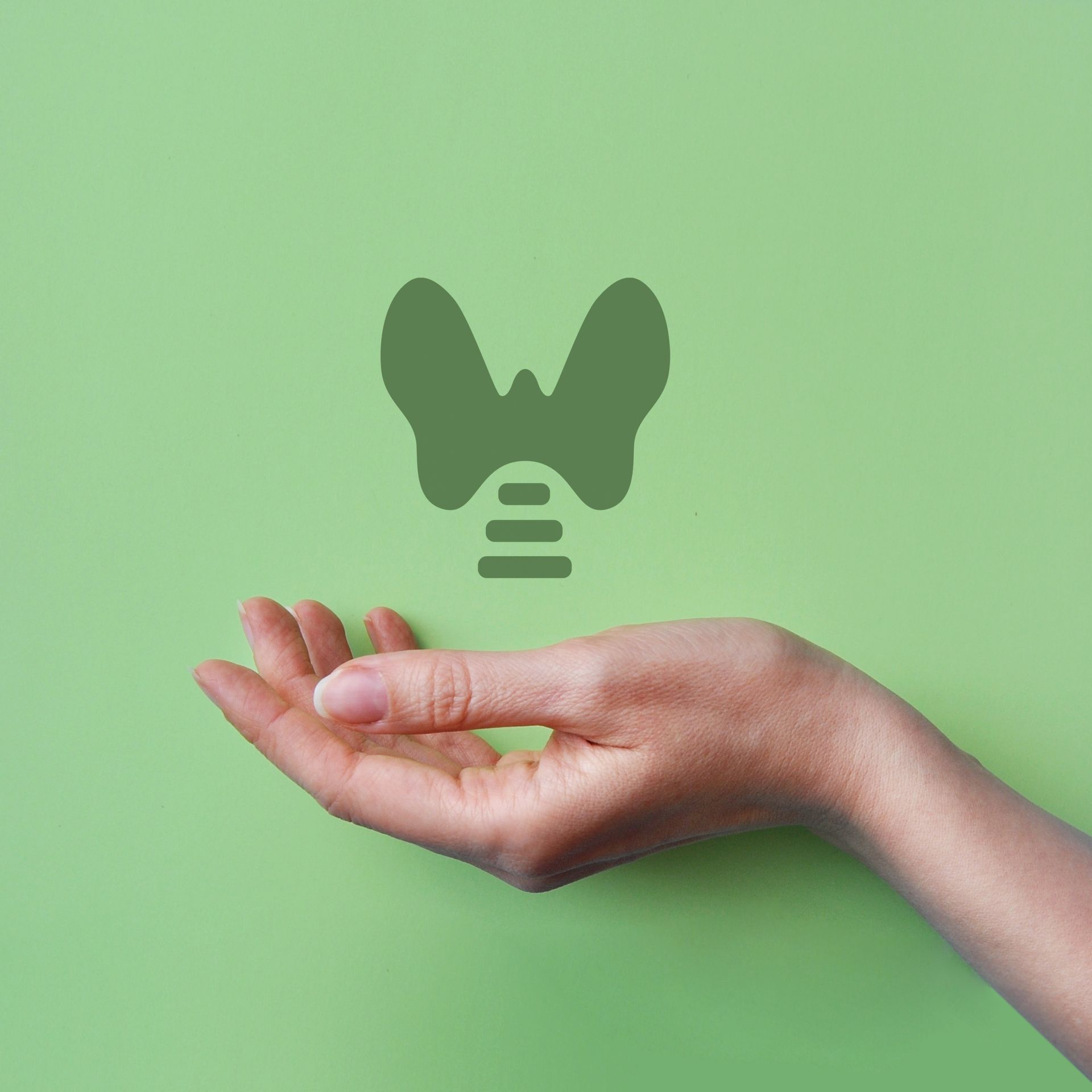 Open hand beneath a green lightbulb icon on a mint background