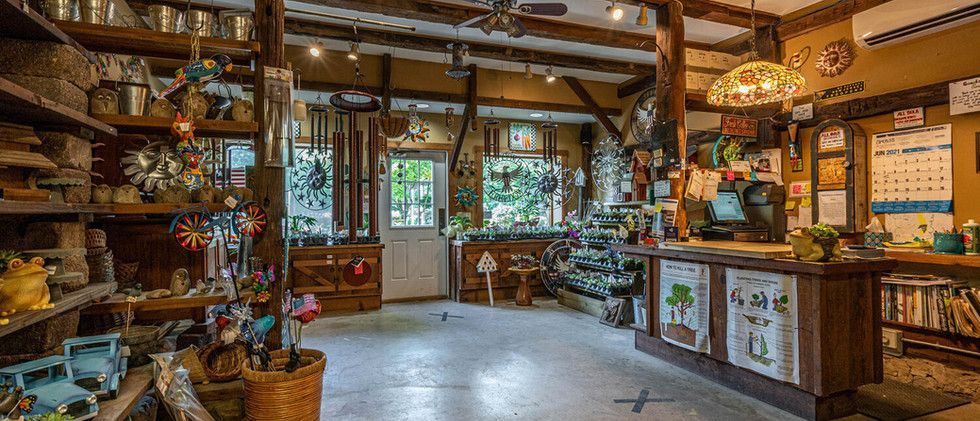 Rustic kitchen with wood beams, colorful decor, and cabinets by large windows