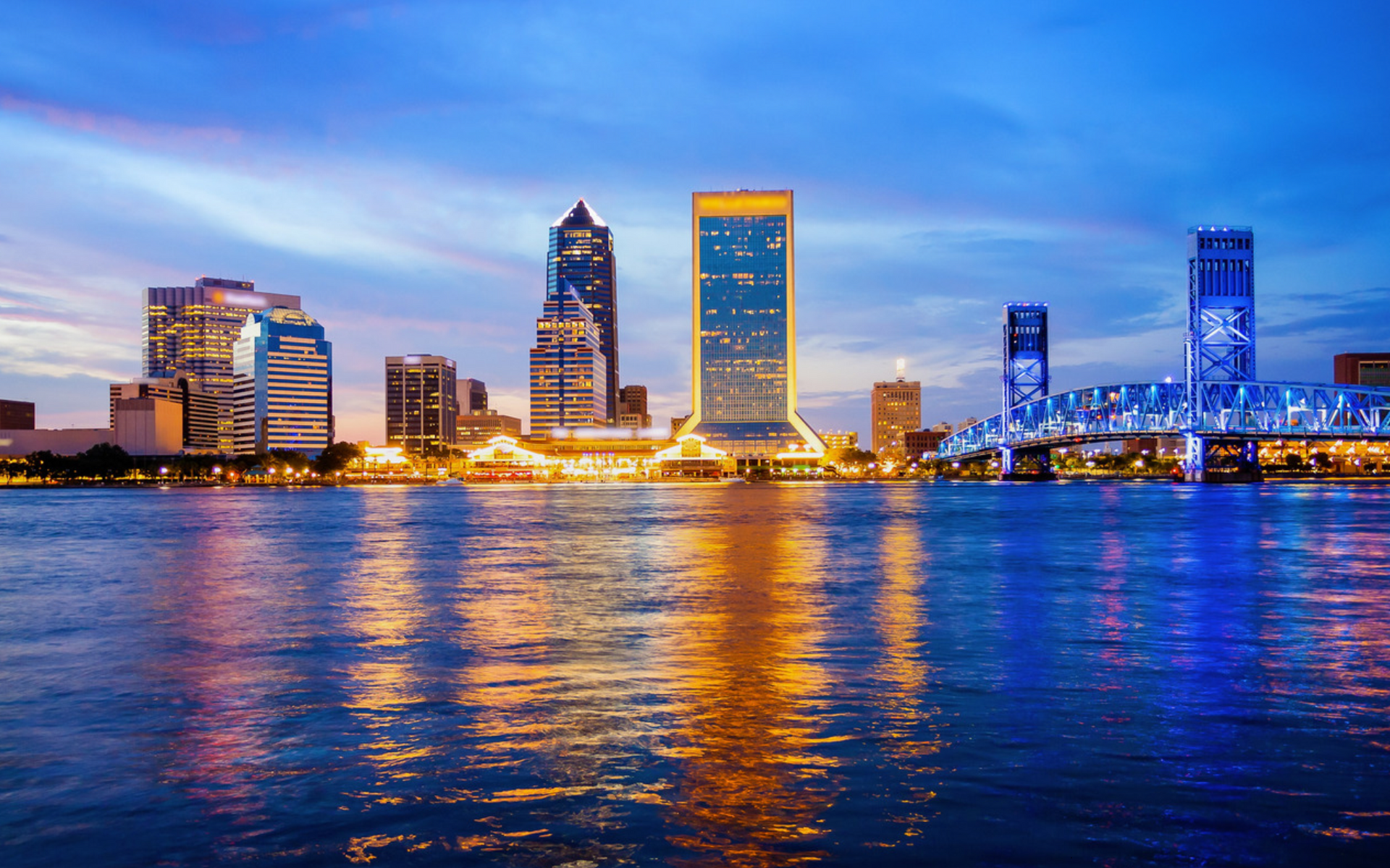 Jacksonville skyline at night with city lights reflecting on the river