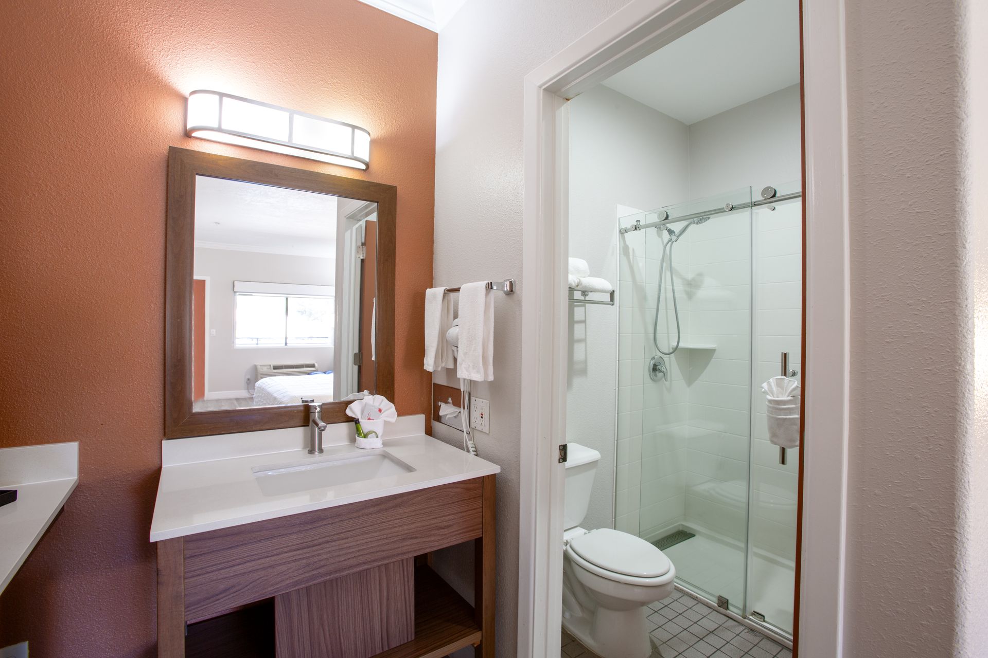 Clean and elegant toilet and walk-in shower area in Panoramic King Fireplace room at Wildflower Inn Sedona