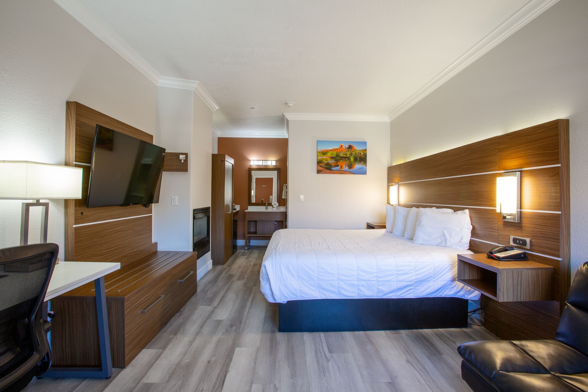 Relaxing Panoramic King Fireplace retreat with plush bedding and nature-inspired decor