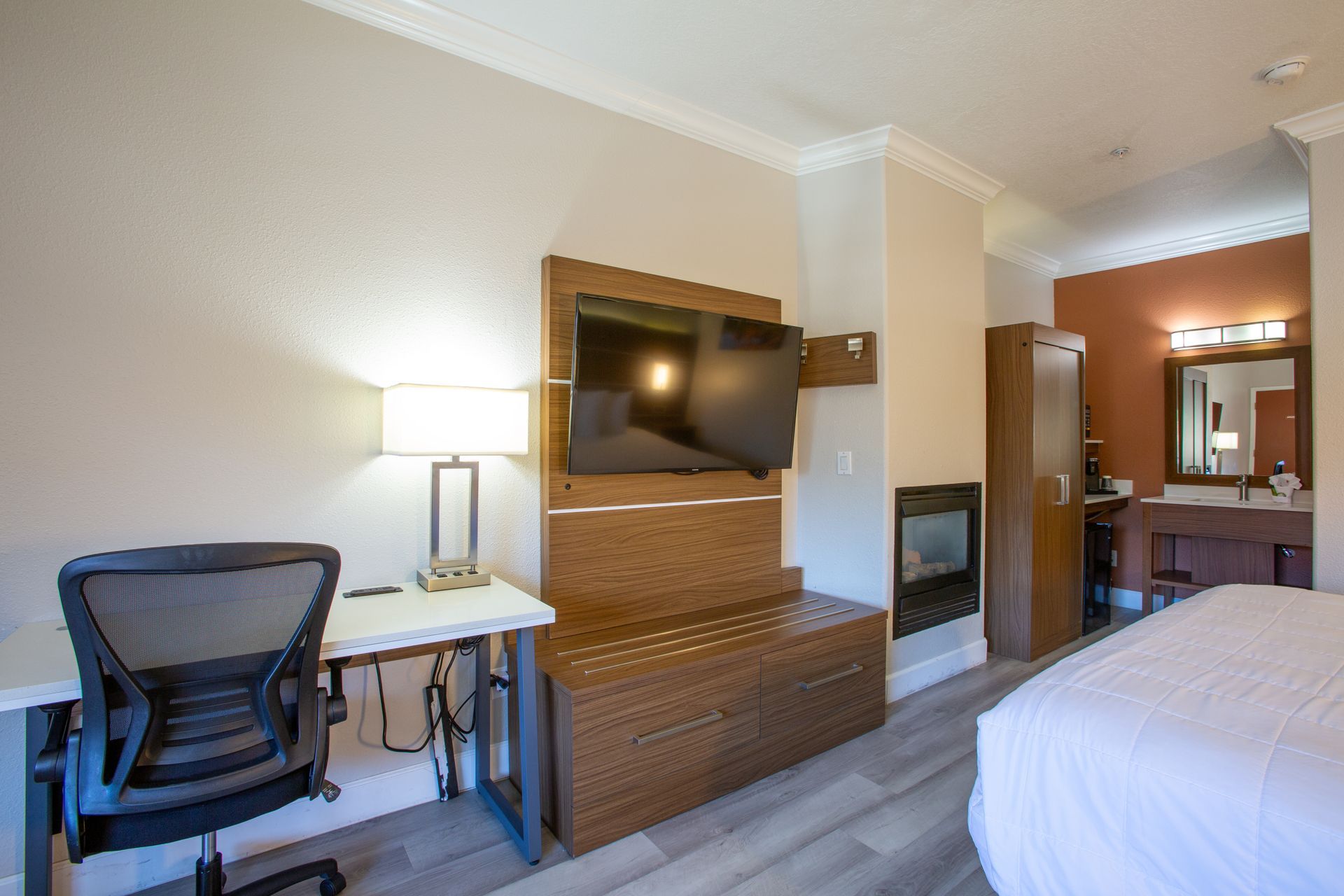 Spacious king bedroom with gas fireplace and scenic balcony views at Wildflower Inn Sedona