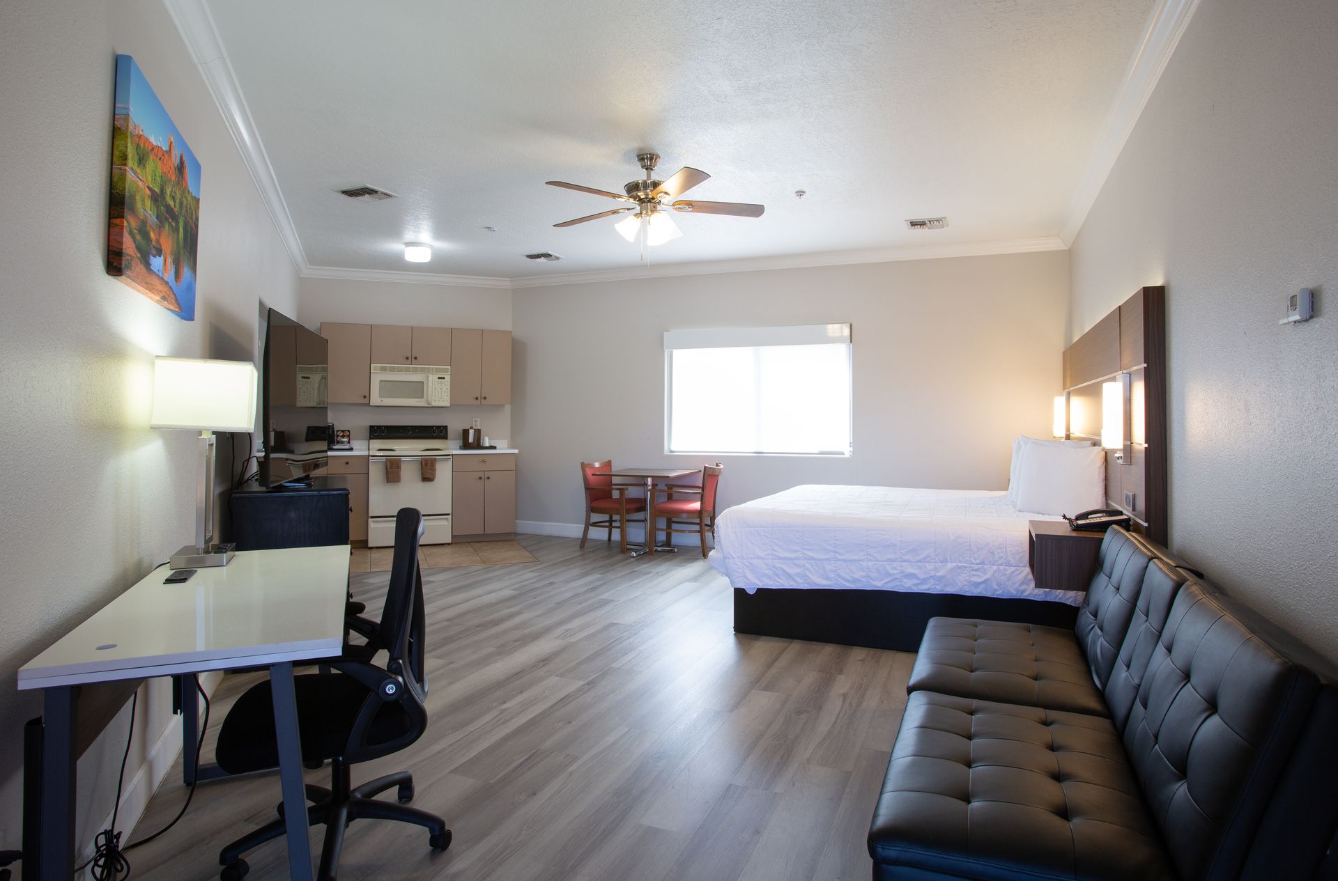 Side view of Cozy Kitchenette King Suite bedroom and kitchen setup at Wildflower Inn Sedona