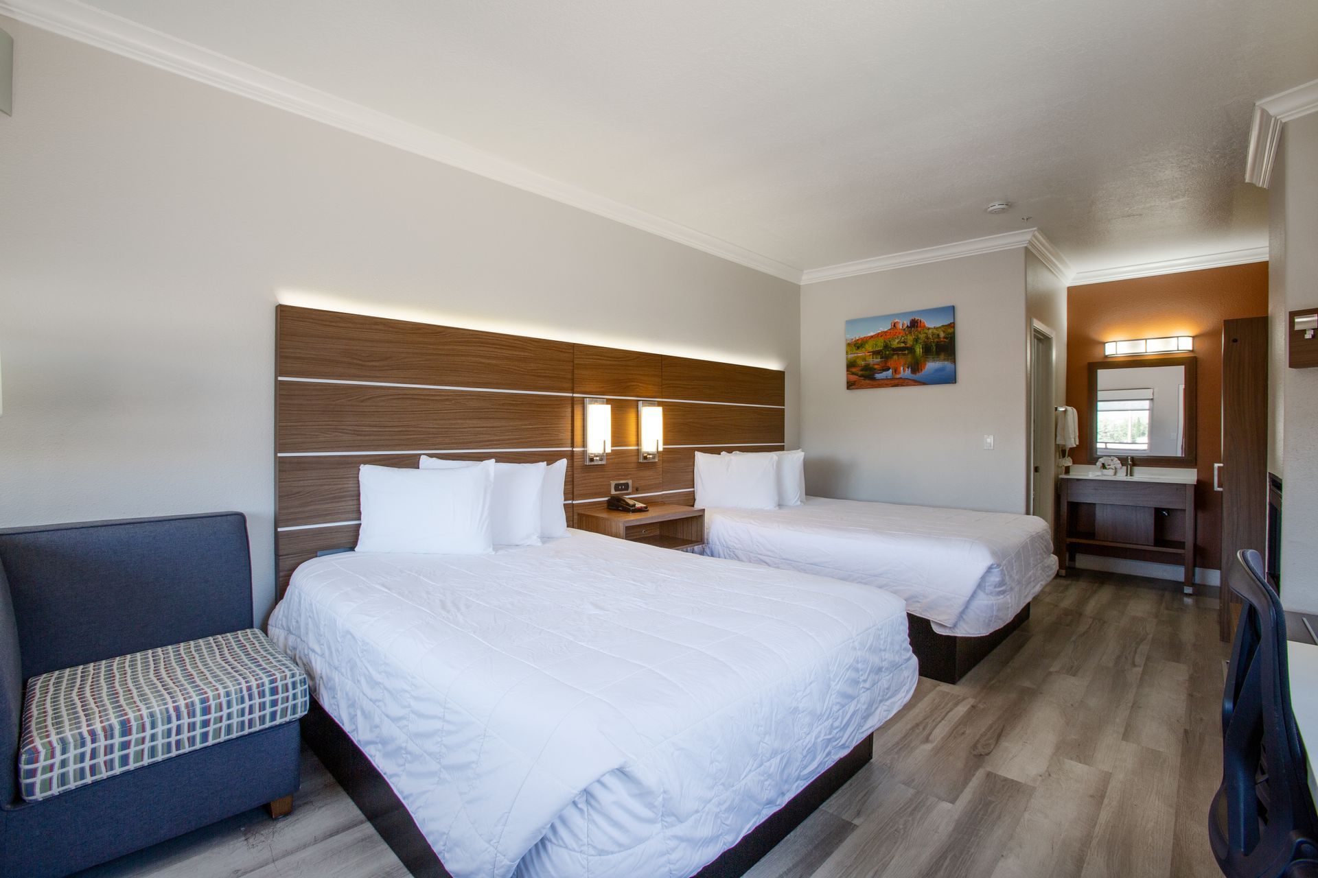 Spacious double queen room at Wildflower Inn featuring a warm gas fireplace