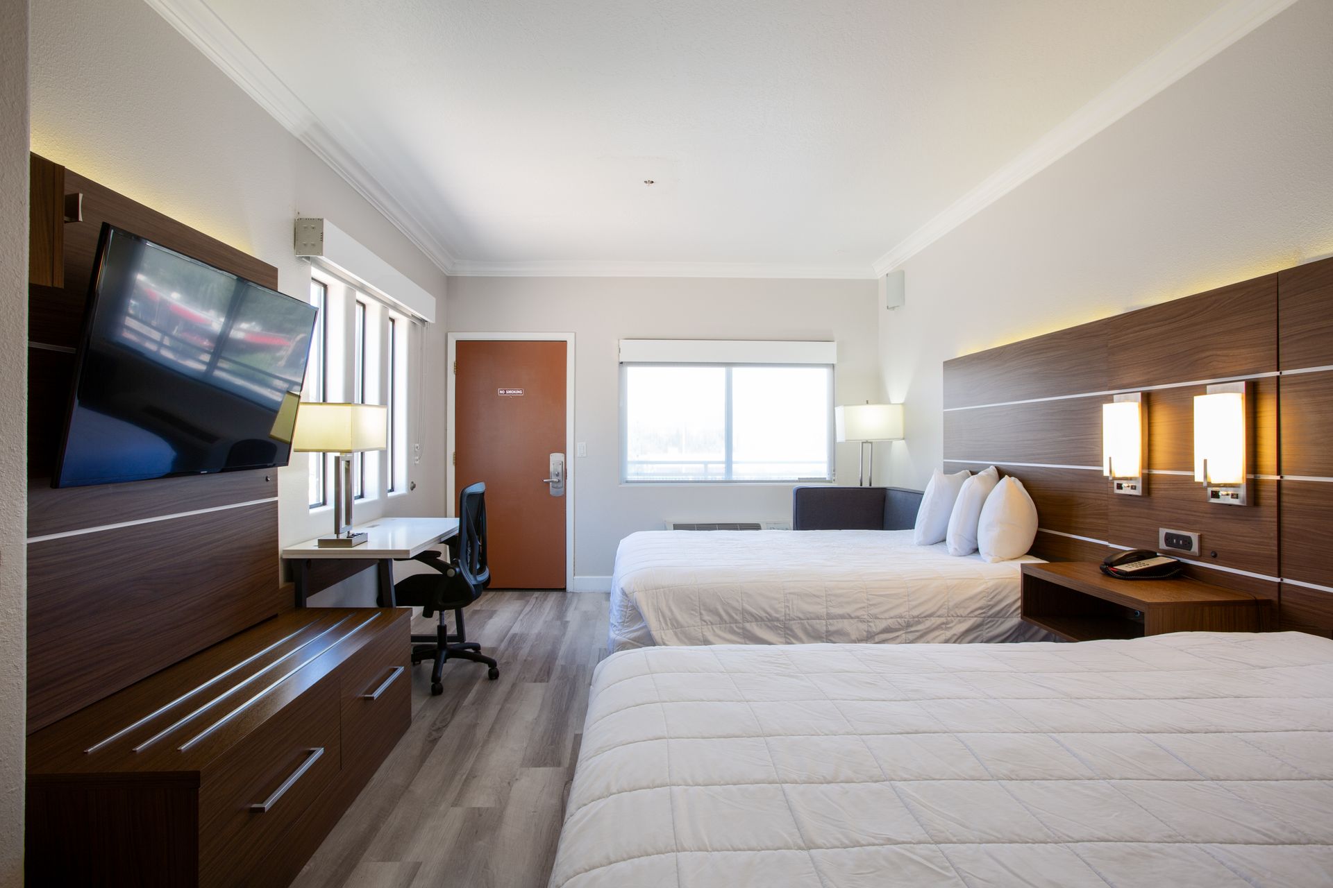 Side view of Cozy Two Queens Fireplace Getaway room with plush beds and fireplace ambiance