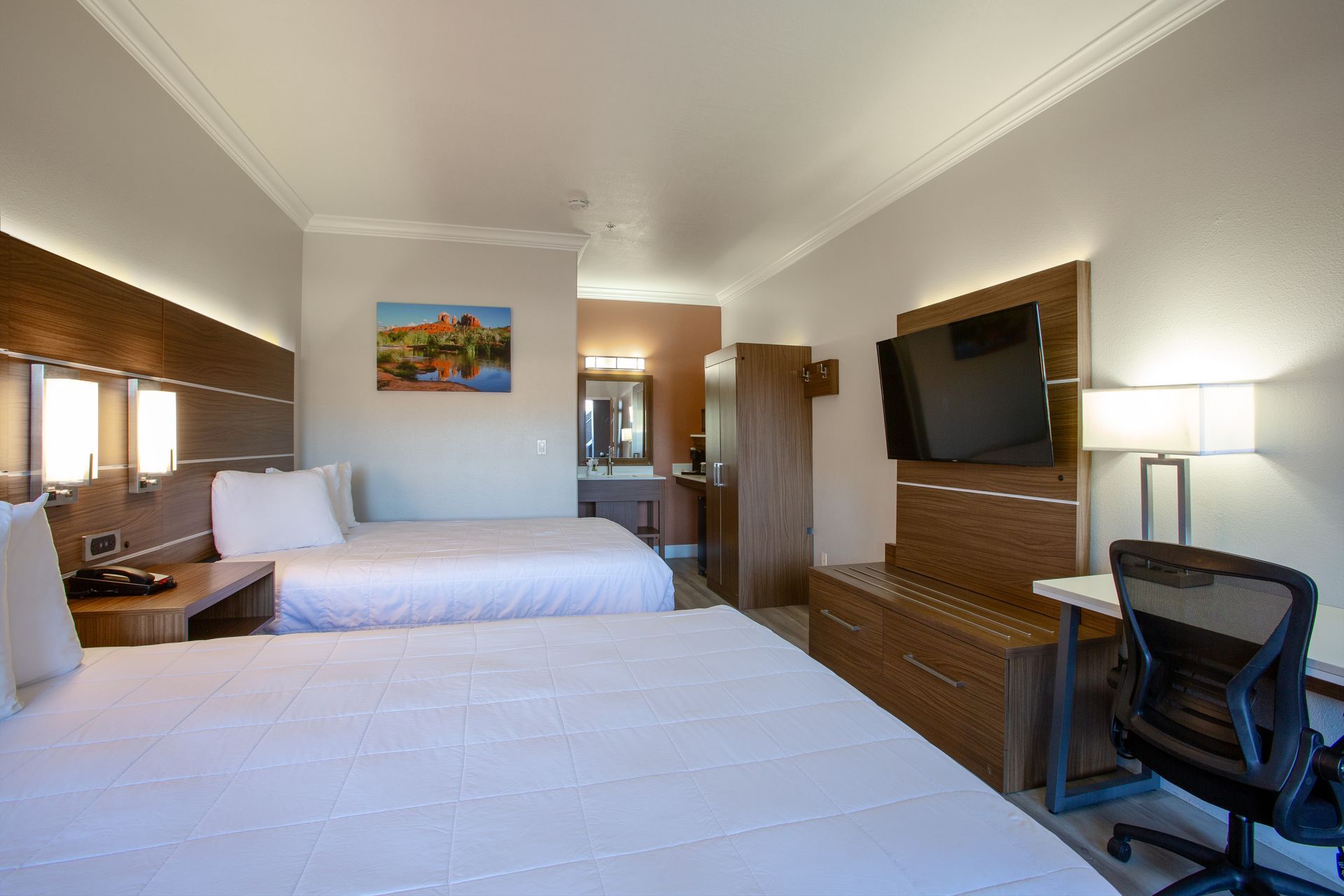 Side view of two plush queen beds in Wildflower Inn’s Ground Level Queen Retreat