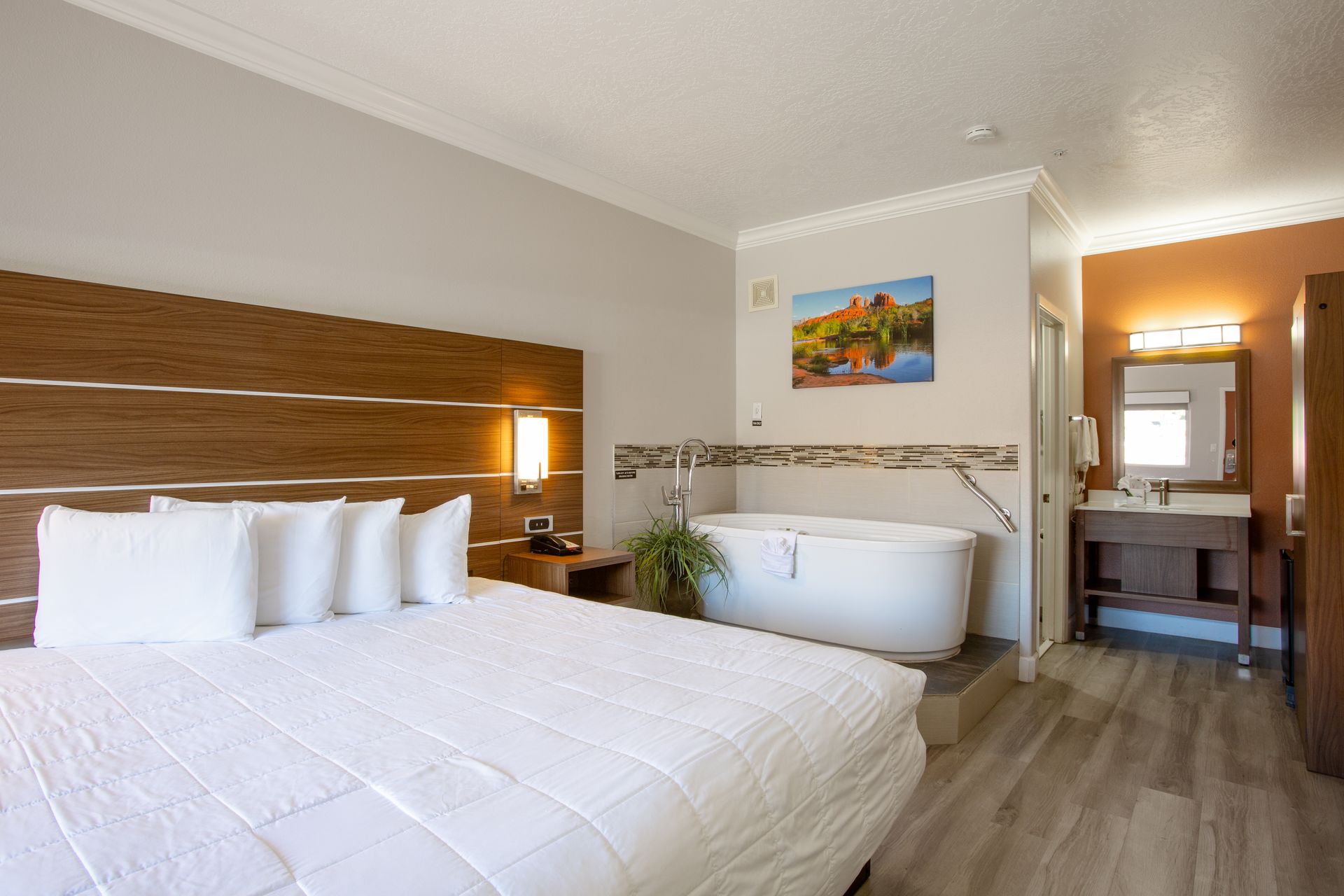 Jetted King Relaxation Retreat interior showcasing luxury bedding and red rock scenery