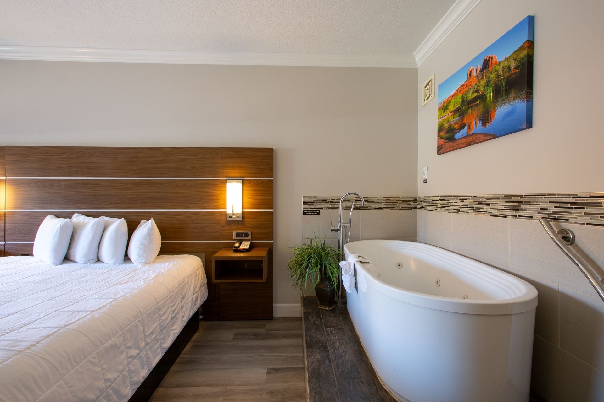 Side view of Jetted King Relaxation Retreat with large bed and whirlpool spa