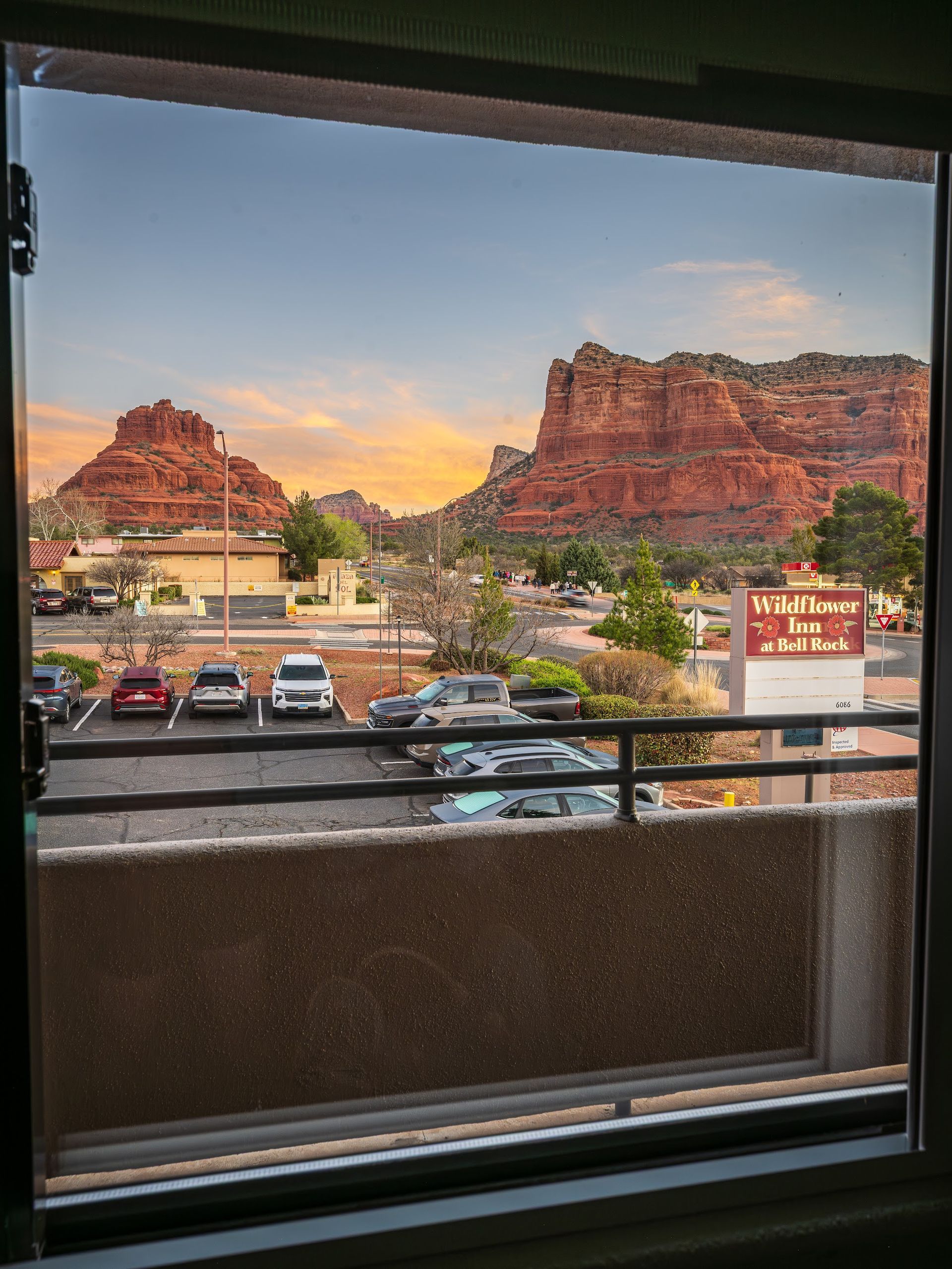 Red rock formations glowing gold at sunset seen from a private balcony at Wildflower Inn at Bell Rock in Sedona Arizona