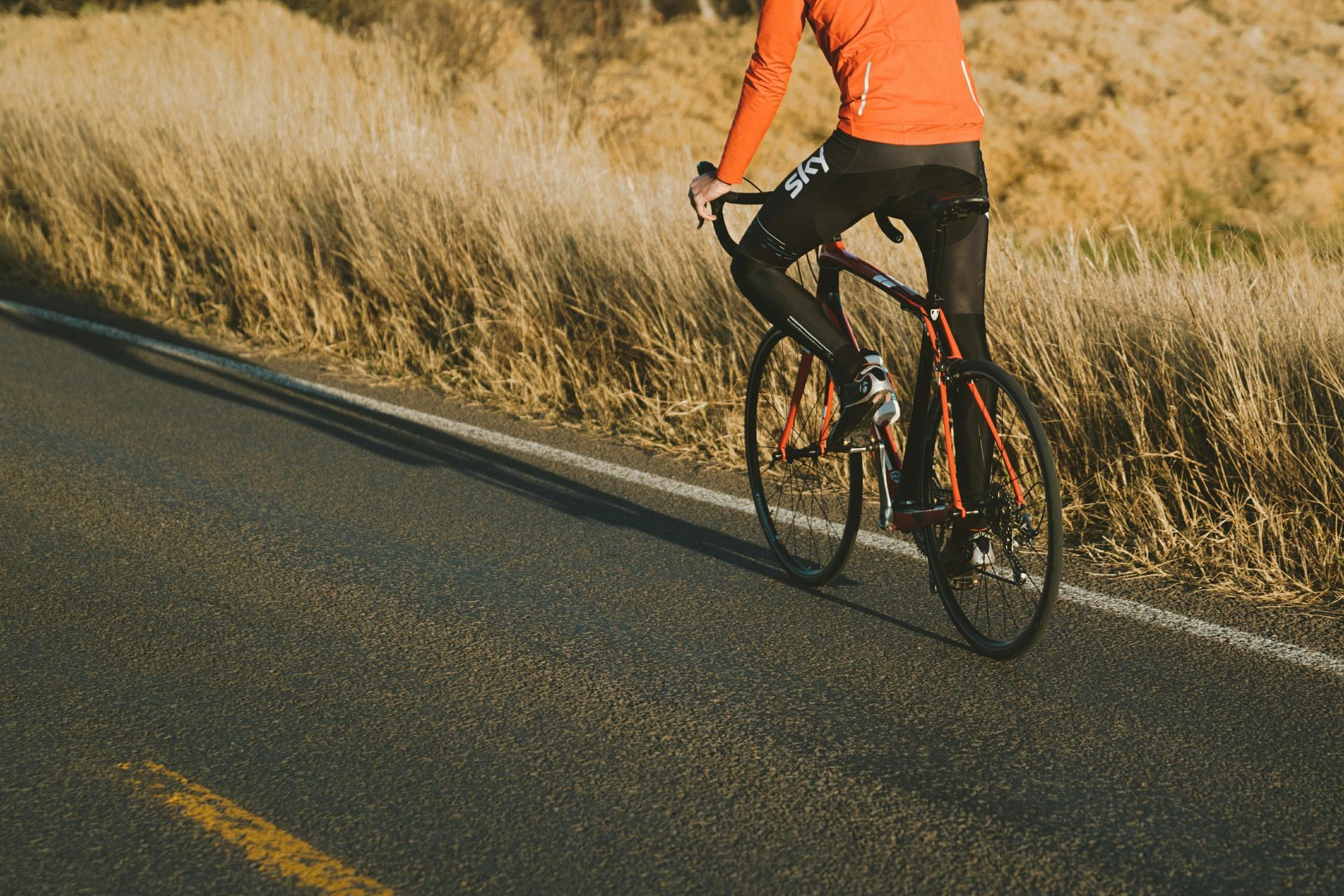 A person is riding a bike down a road.