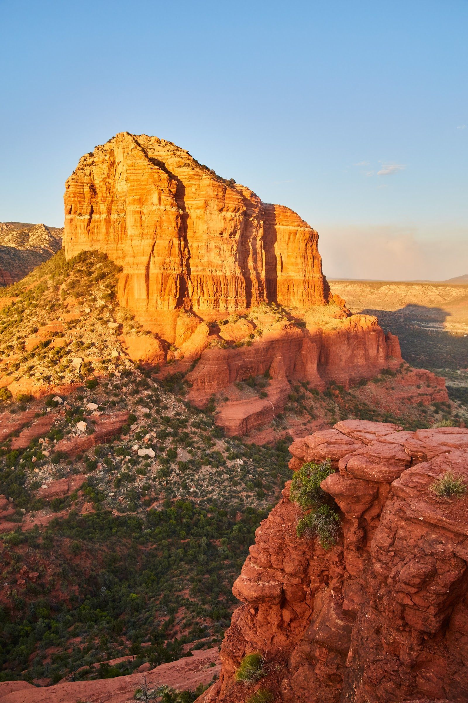 Golden hour light on the striking strata of Bell Rock in Sedona, Arizona