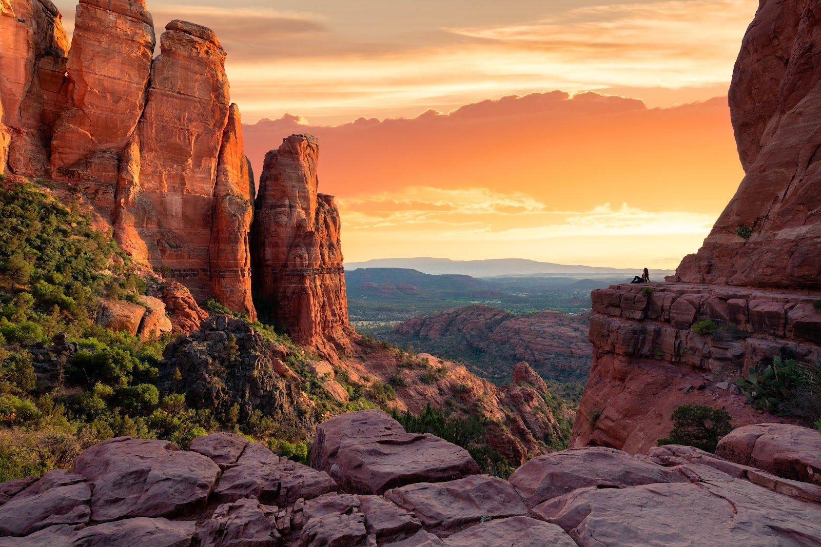 Layered red rock spires glowing orange at last light in Sedona