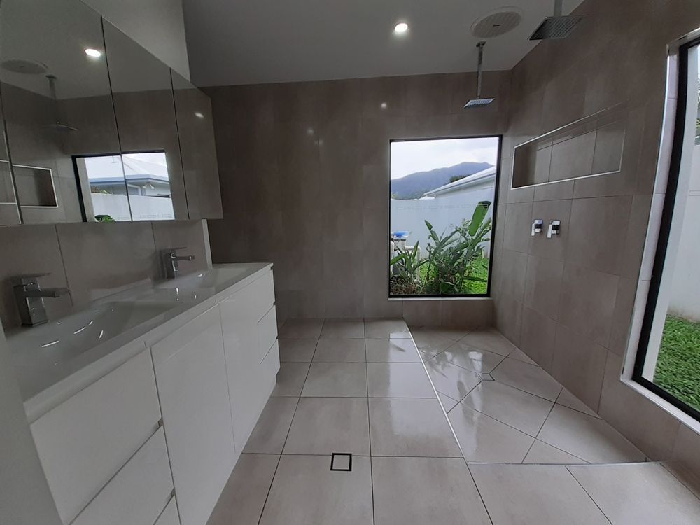 A Bathroom with A Sink and A Window with A View of The Ocean — Cairns Vacate Clean in Manunda, QLD